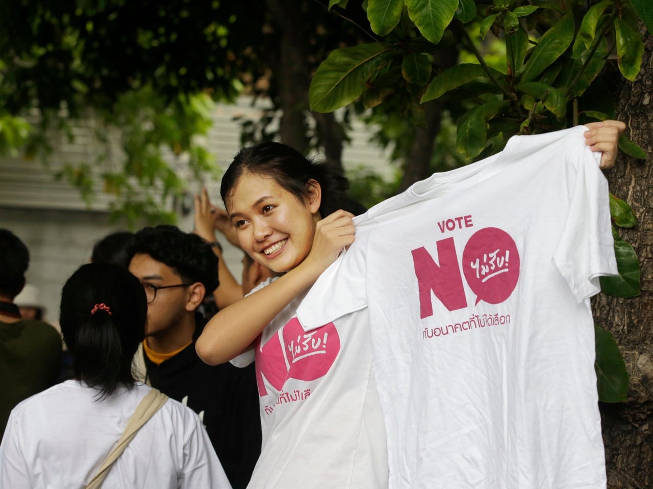 A student from Thammasat University displays a t-shirt saying "vote no" in a protest to mark the second anniversary of the military take over of the government in Bangkok, Thailand, 22 May 2016, AP Photo/Mark Baker