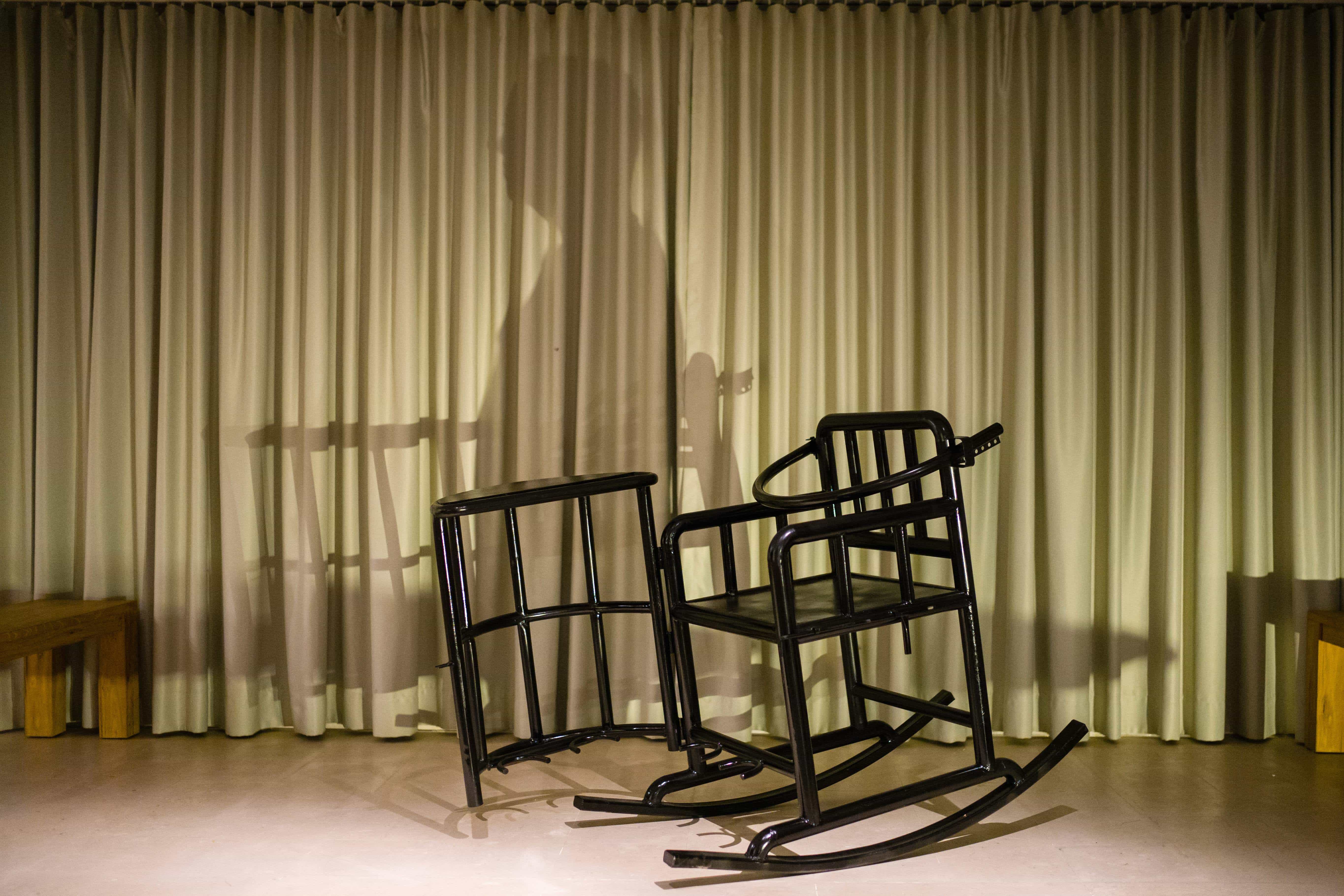 Shadow of political cartoonist Badiucao projected on a 'tiger chair' - used to interrogate detainees - in place of his art show, which was cancelled by authorities, Hong Kong, 2 November 2018, ANTHONY WALLACE/AFP/Getty Images