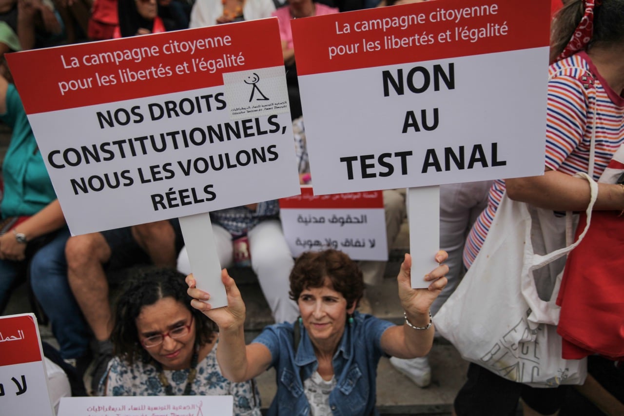 A woman holds a placard which reads 'no to the anal test' during a demonstration on National Women's Day in Tunis, 13 August 2018, Chedly Ben Ibrahim/NurPhoto via Getty Images