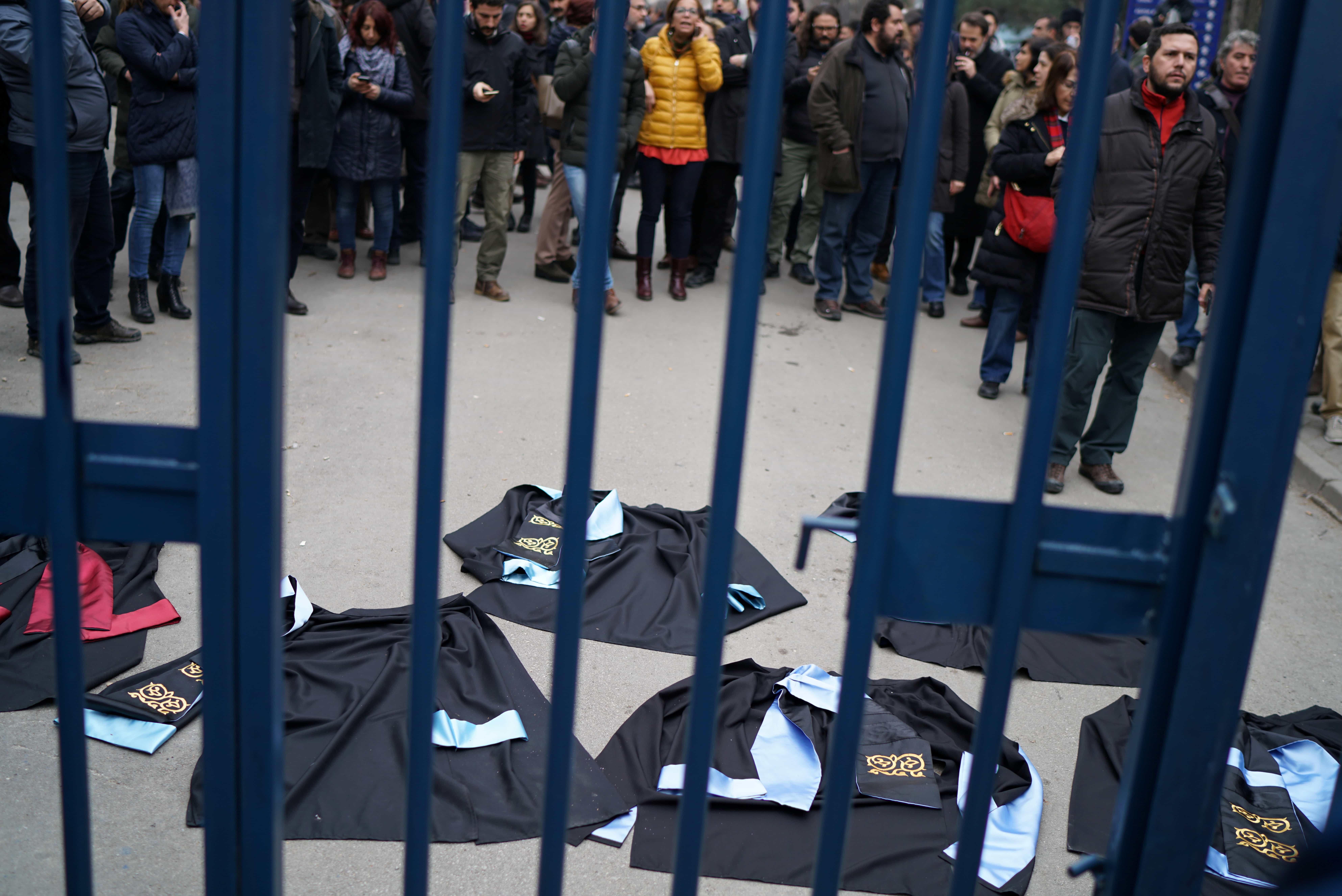 Professors lay down their gowns during a protest against the dismissal of academics, at the Cebeci campus of Ankara University in Ankara, Turkey, 10 February 2017, REUTERS/Umit Bektas