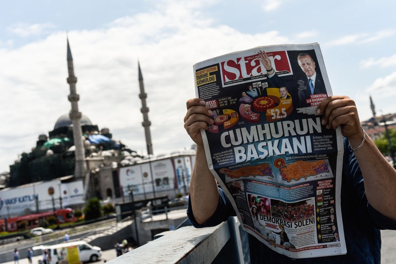 A man reads a daily newspaper announcing the results of the presidential and parliamentary elections in Istanbul, Turkey, 25 June 2018, YASIN AKGUL/AFP/Getty Images