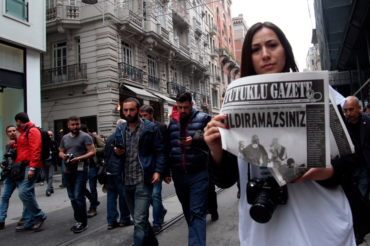 A female journalist holds a copy of "The Prisoner" newspaper which reads "you can not discourage us" during a World Press Freedom Day rally in Istanbul, Turkey, 3 May 2015, Basin Foto Ajansi/LightRocket via Getty Images