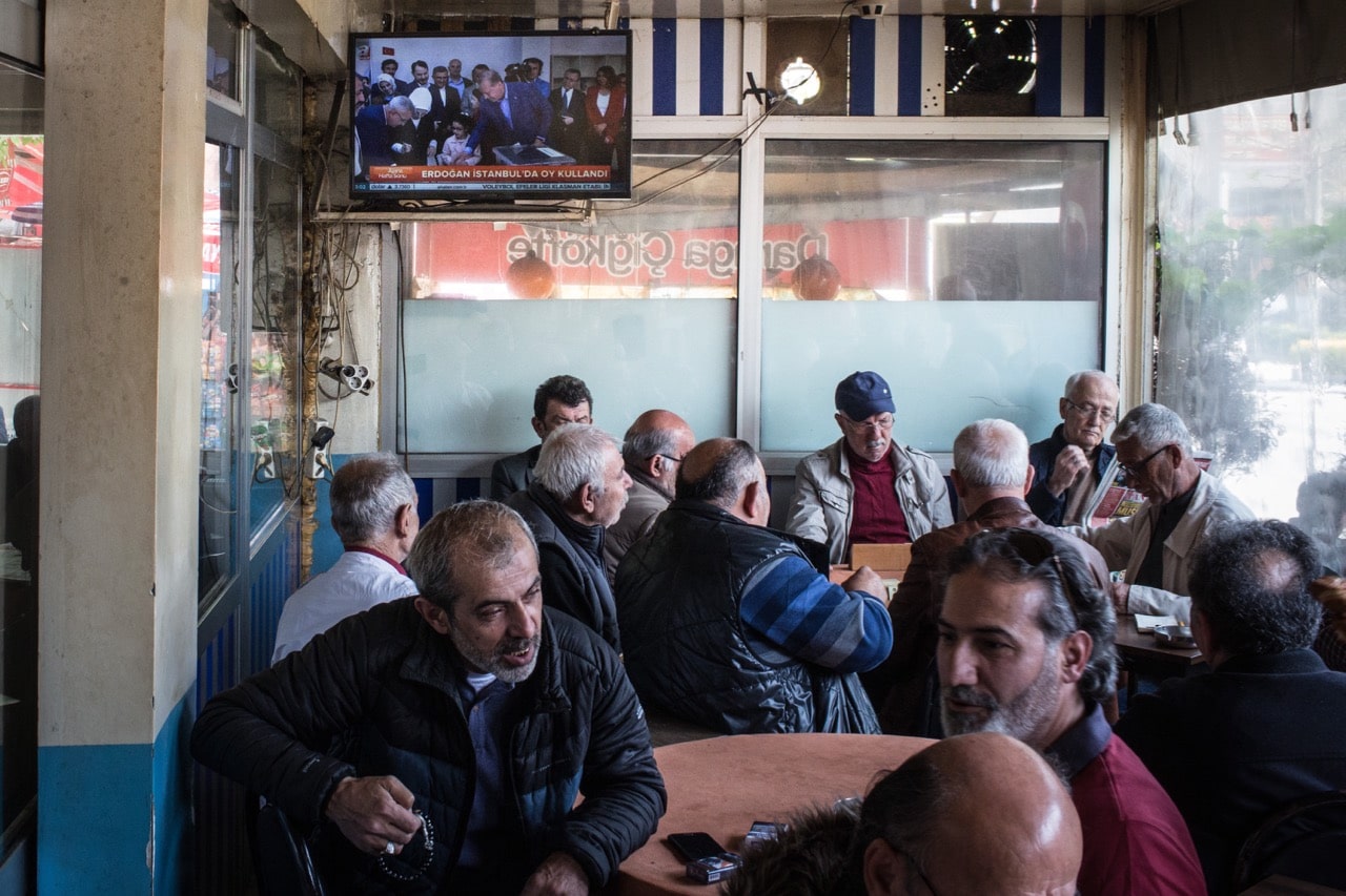 Men chat and drink chai at a teahouse while footage of Turkish President Recep Tayyip Erdogan is seen on a TV in Istanbul, Turkey, 16 April 2017, Chris McGrath/Getty Images