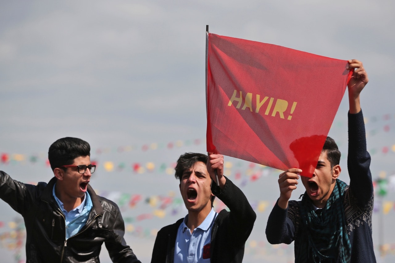 In the mainly Kurdish city of Diyarbakir, on 21 March 2017, young men hold a flag that says "NO", in reference to President Erdogan's bid to gain more power in the 16 April referendum, AP Photo/Lefteris Pitarakis