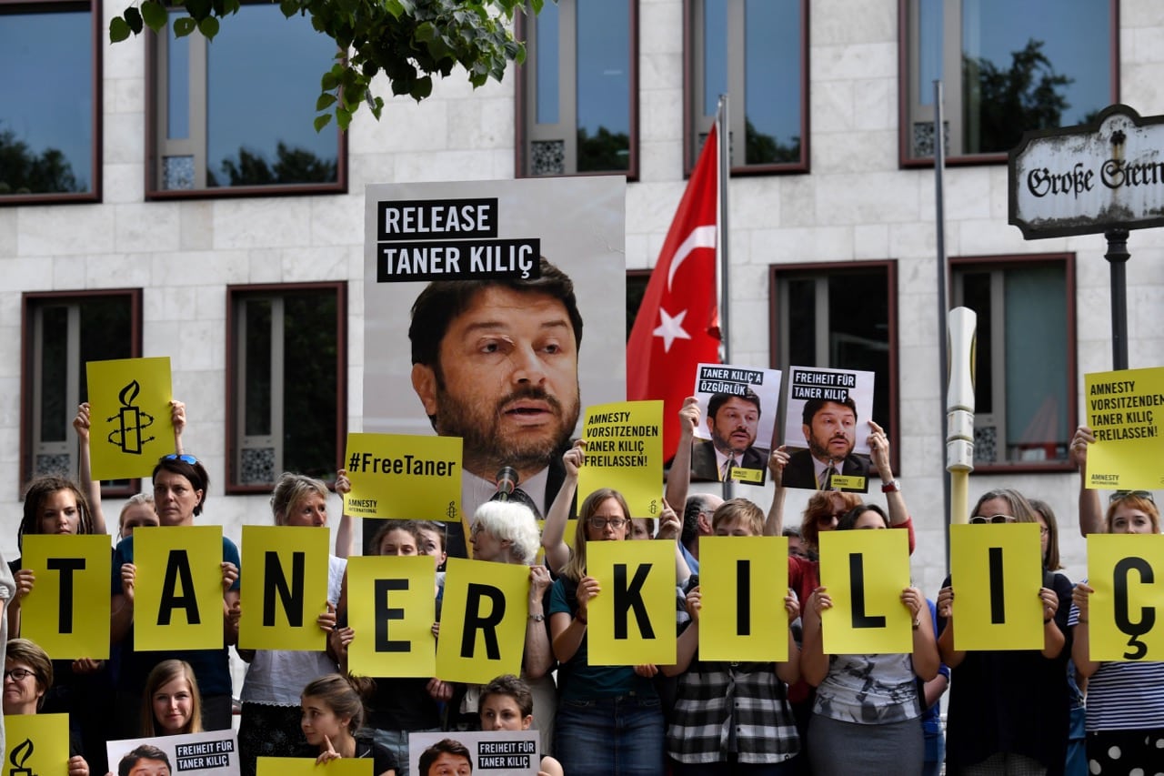 Amnesty International activists stage a protest against the detention of the head of Amnesty in Turkey, Taner Kilic, in front of the Turkish Embassy in Berlin, 15 June 2017 , JOHN MACDOUGALL/AFP/Getty Images