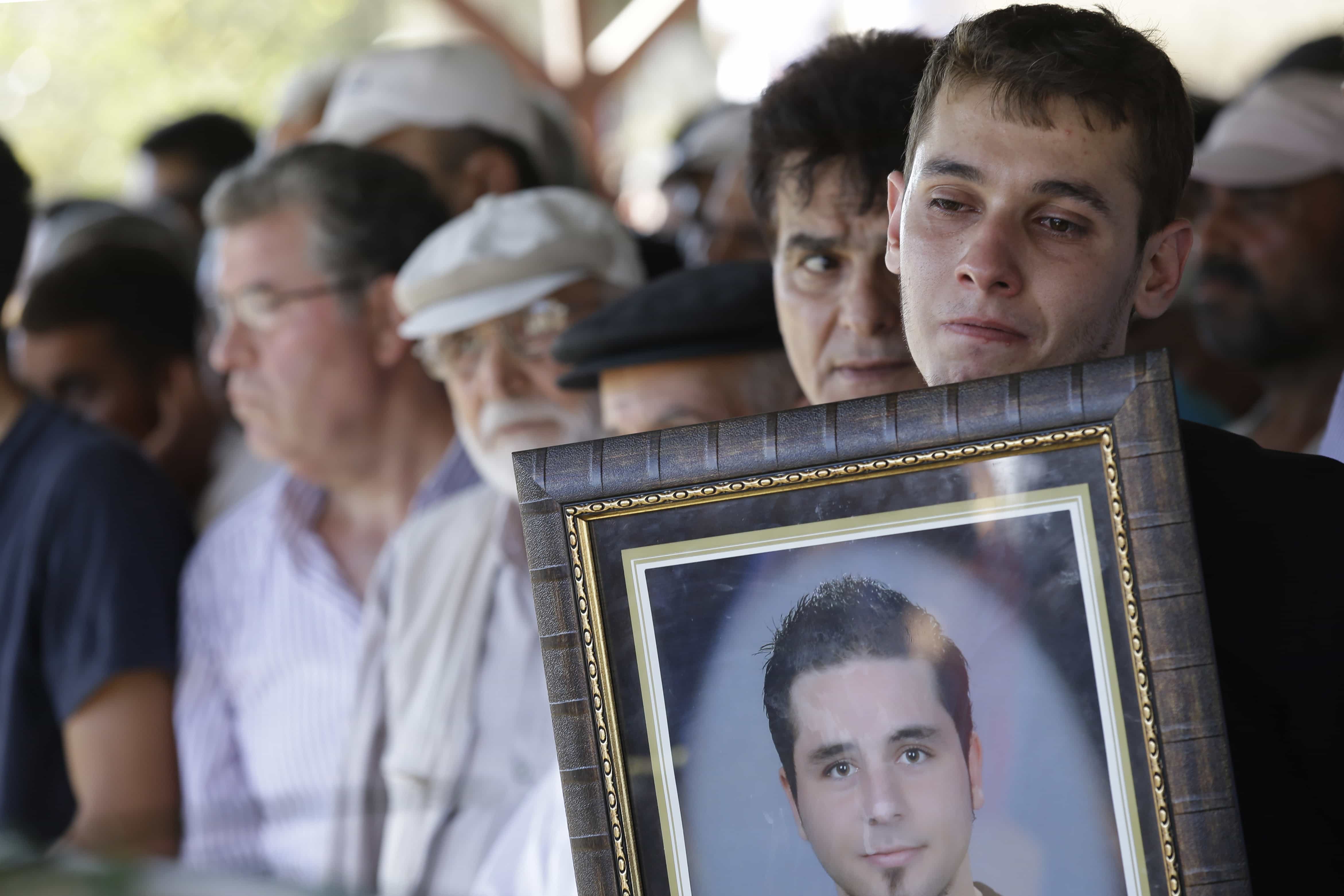 A picture of Ahmet Atakan is shown during his funeral service, 10 September 2013., AP Photo/Gregorio Borgia