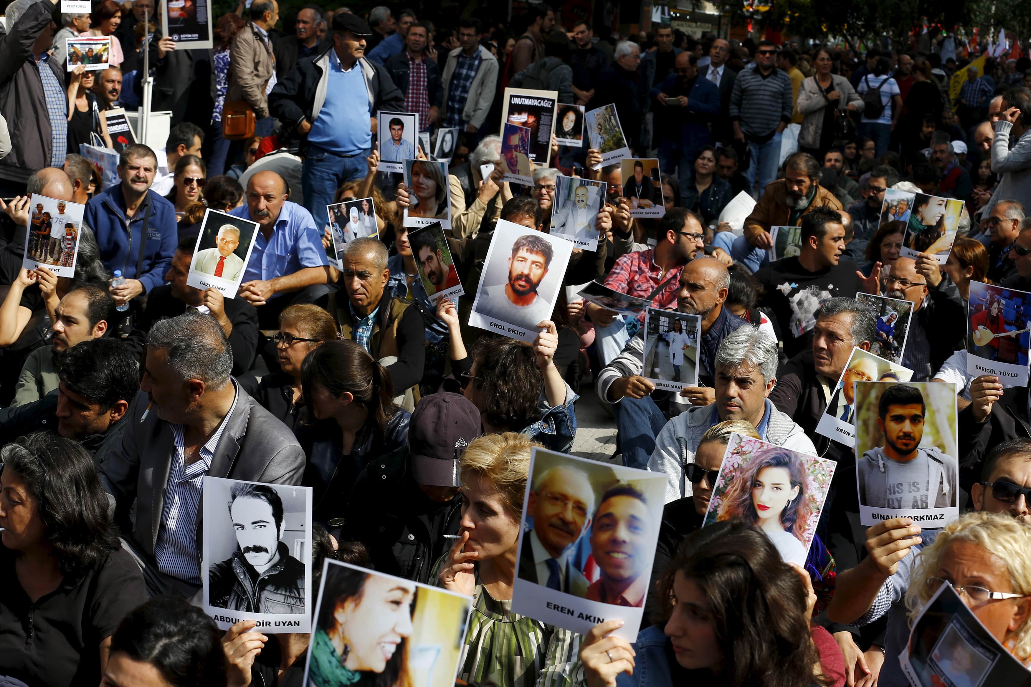 Demonstrators hold portraits of those killed by Saturday's suicide bombings as they attend a commemoration in Ankara, 13 October 2015, REUTERS/Umit Bektas