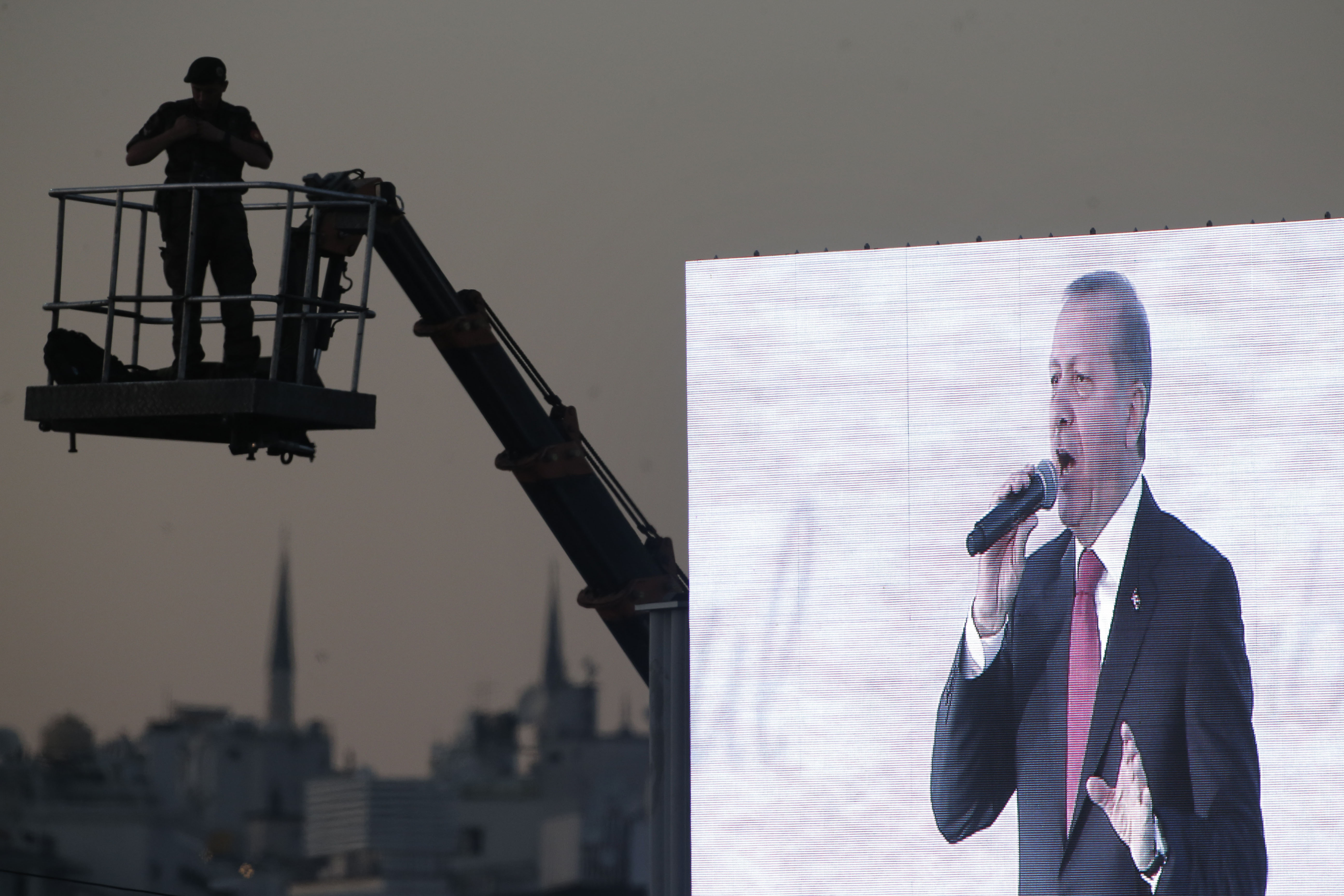 An officer secures the area on an elevated platform as President Erdogan delivers a speech in Istanbul, 30 May 2015, AP Photo/Lefteris Pitarakis