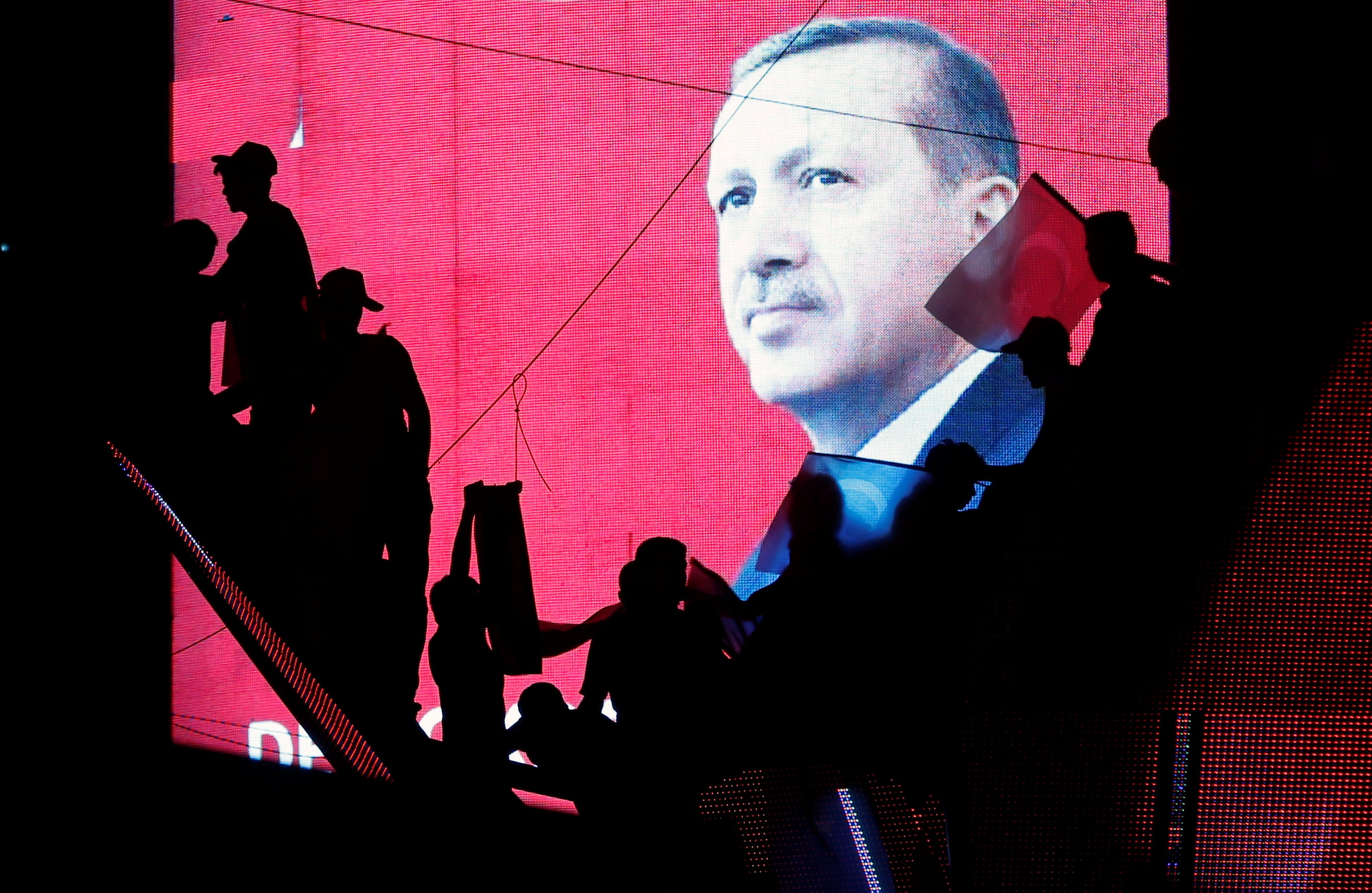 Turkish Supporters are silhouetted against a screan showing President Tayyip Erdogan during a pro-government demonstration in Ankara, Turkey 17 July 2016, REUTERS/Baz Ratner