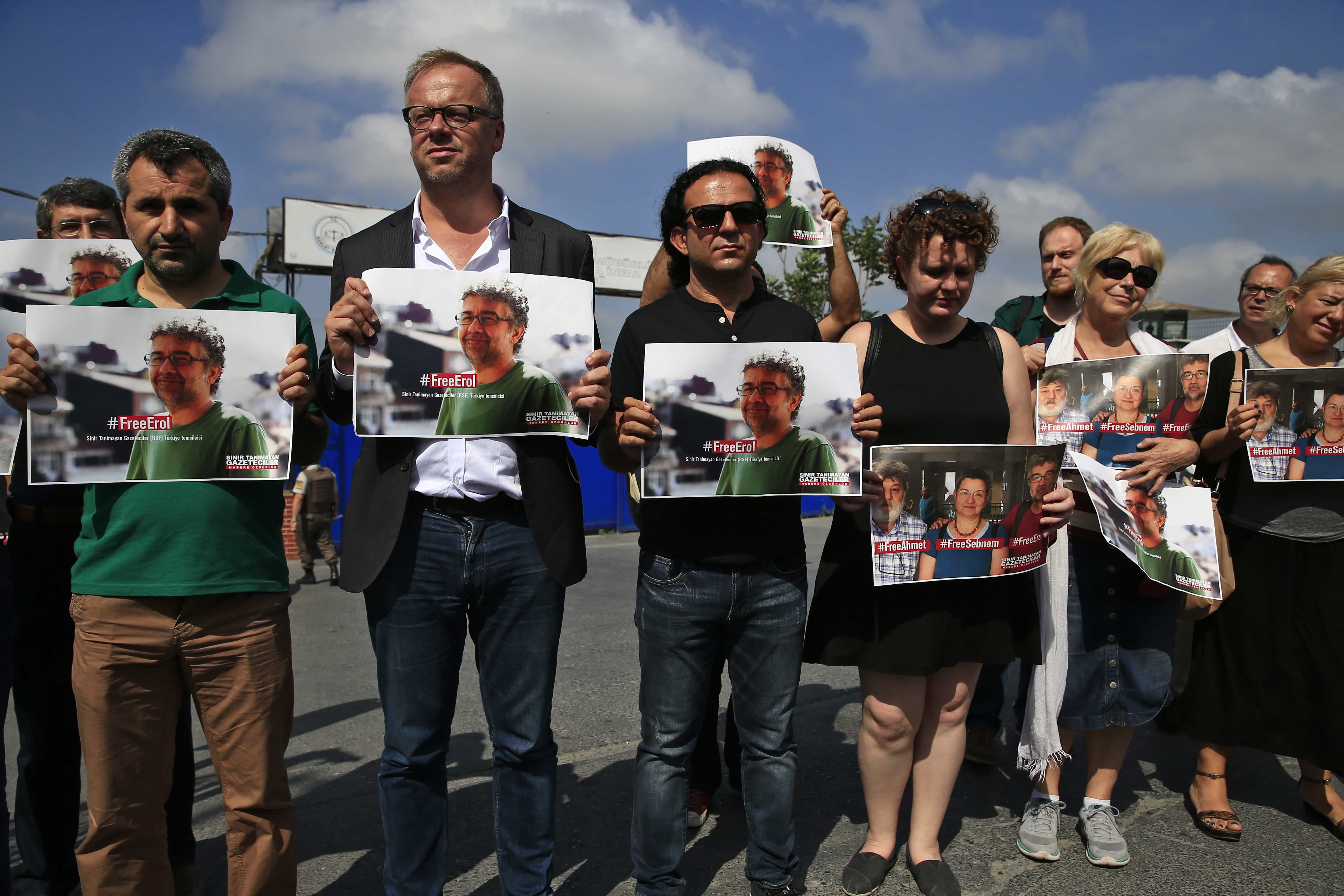 Protesters, including Reporters Without Borders' Secretary General Christophe Deloire, holding pictures of RSF local representative Erol Onderoglu, academic Sebnem Korur Fincanci and journalist Ahmet Nesin, outside Metris prison in Istanbul, 24 June 2016., AP Photo/Lefteris Pitarakis