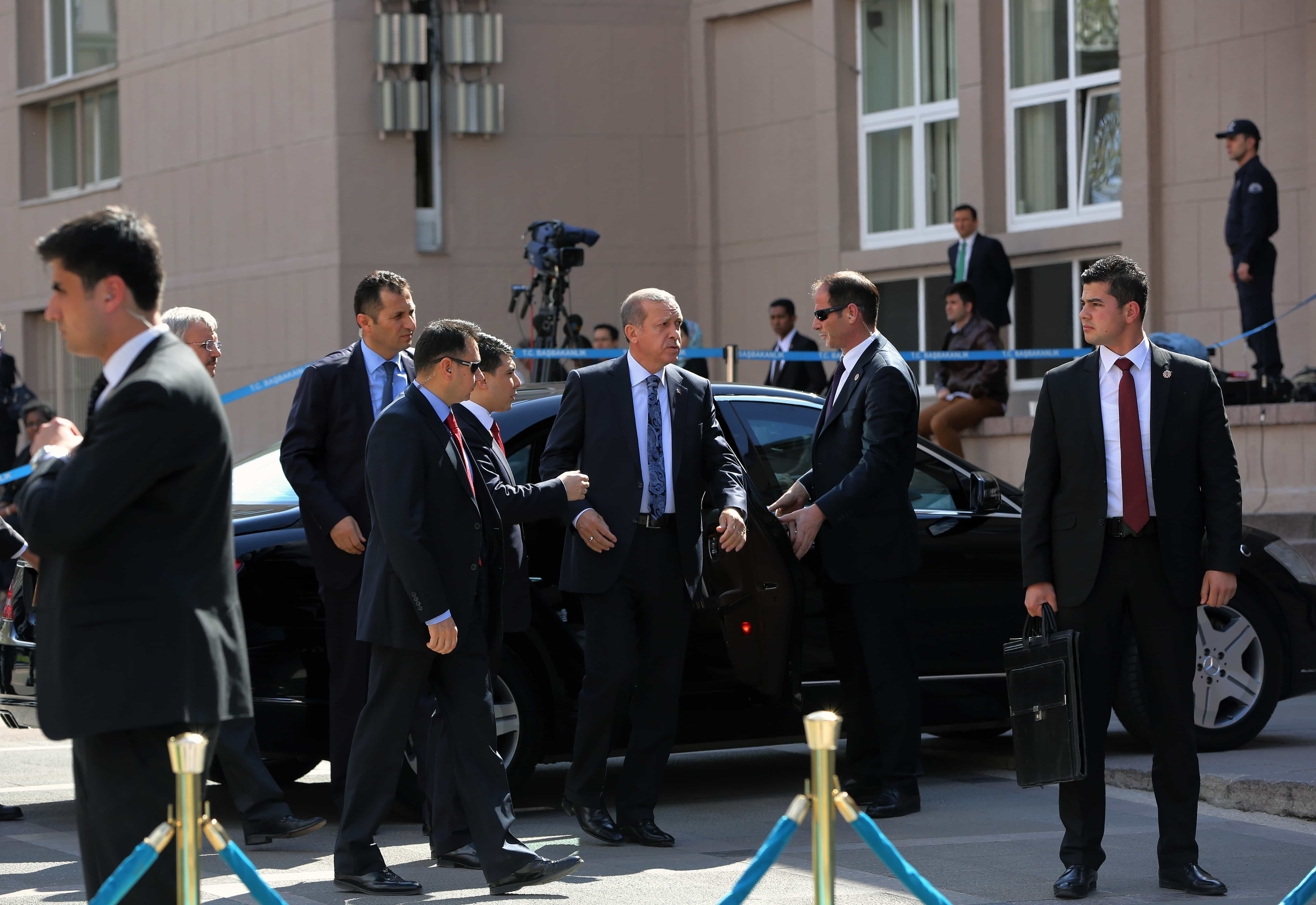 Turkish Prime Minister Recep Tayyip Erdogan, centre, is surrounded by his security members outside his office in Ankara, 17 April 2014., AP Photo/Burhan Ozbilici