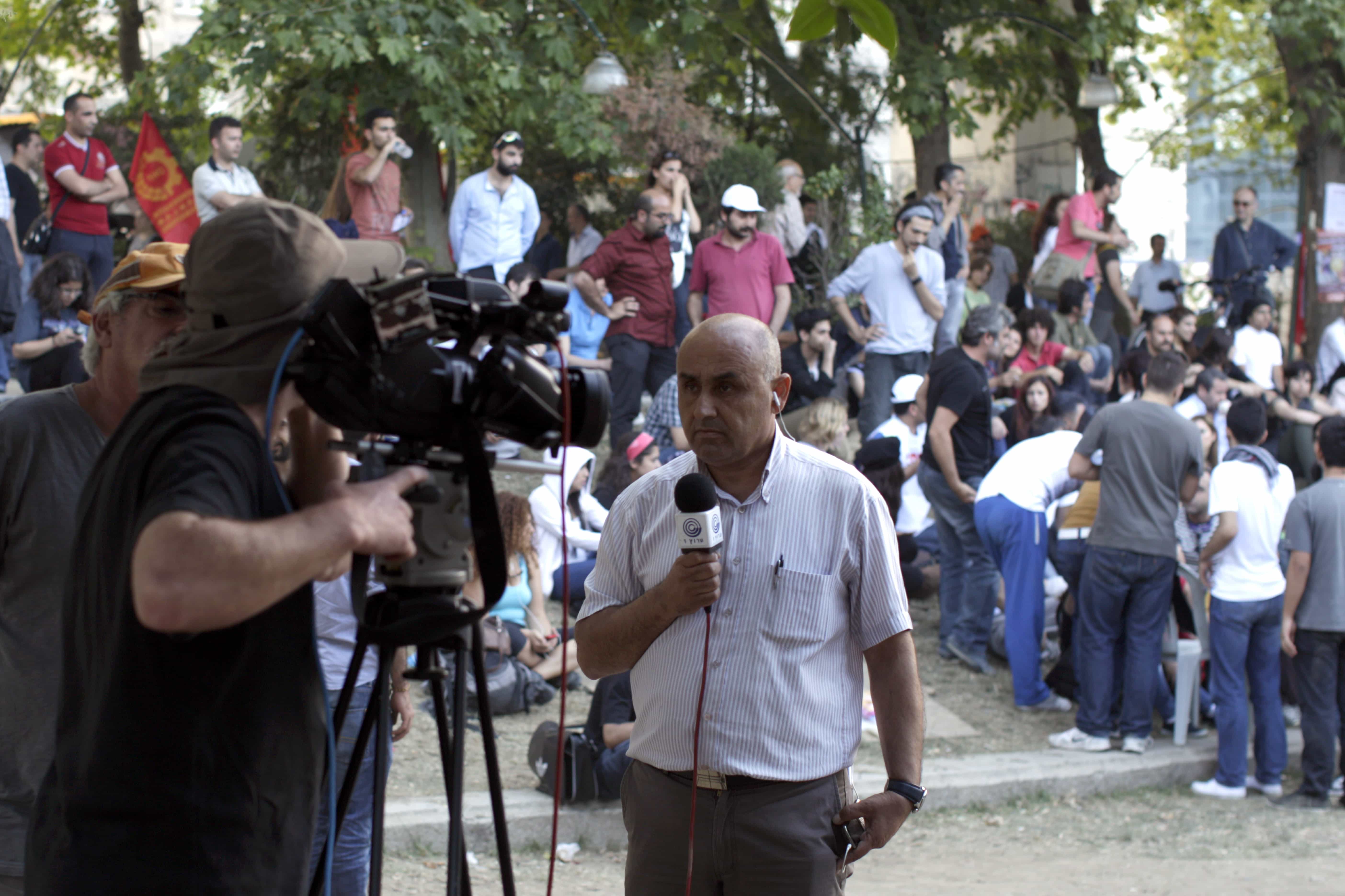 A TV journalist reports at Gezi park in Istanbul, 4 June 2013., AP Photo/Kostas Tsironis