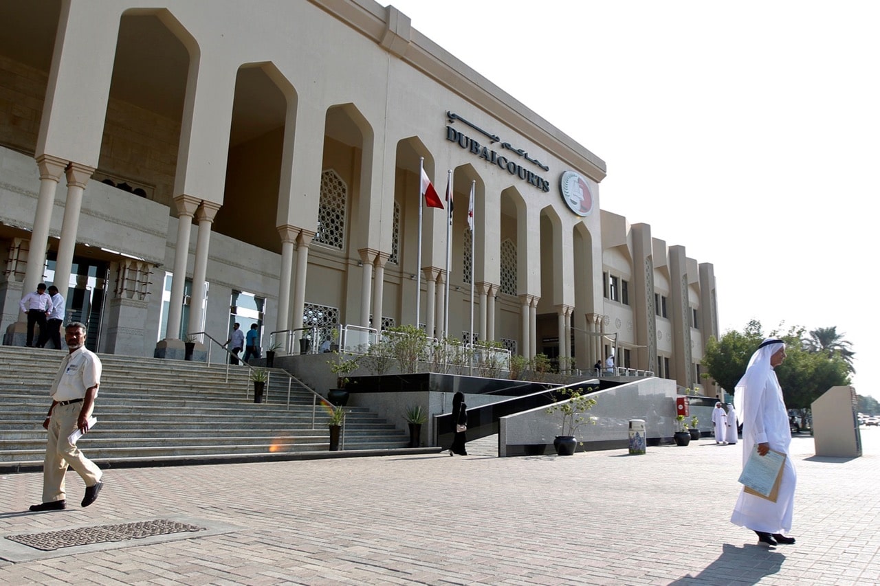 A man walks past the Dubai Courts, 1 November 2012, REUTERS/Jumana ElHeloueh