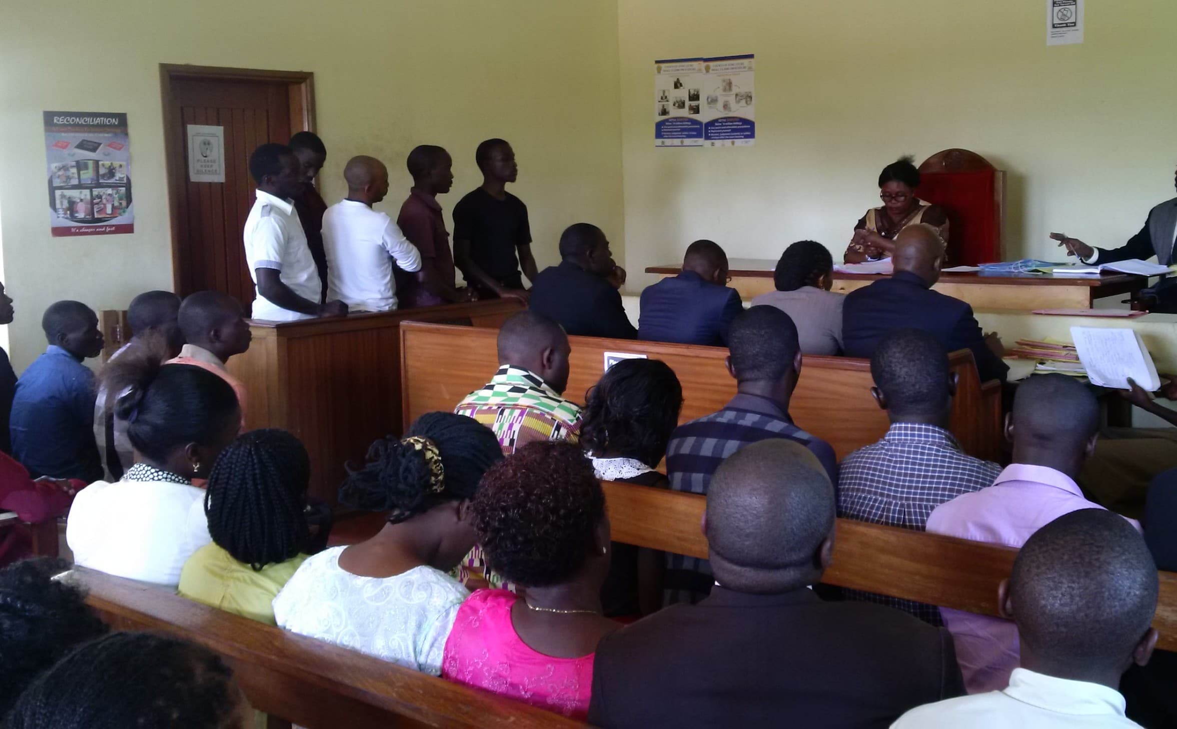 NRM youth supporters convicted of assaulting journalists standing in the dock during court judgement., Emmanuel Magambo