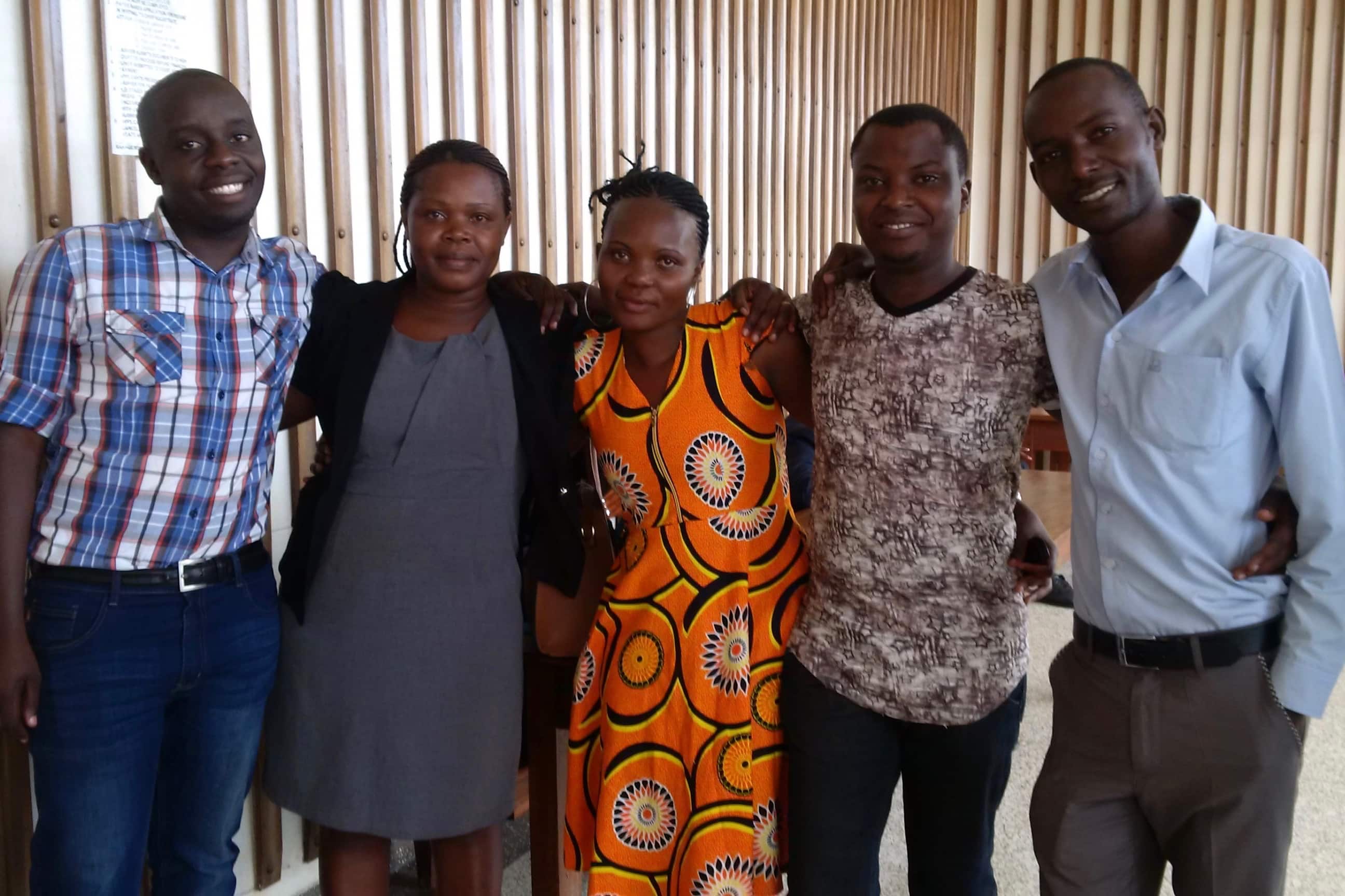 Journalists with an HRNJ-Uganda lawyer (2nd left) after the court had acquitted them, Emmanuel Magambo