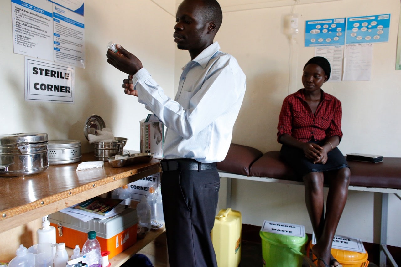 A doctor and patient in Bweyale medical center, northern Uganda, 2 March 2016, Godong/UIG via Getty Images