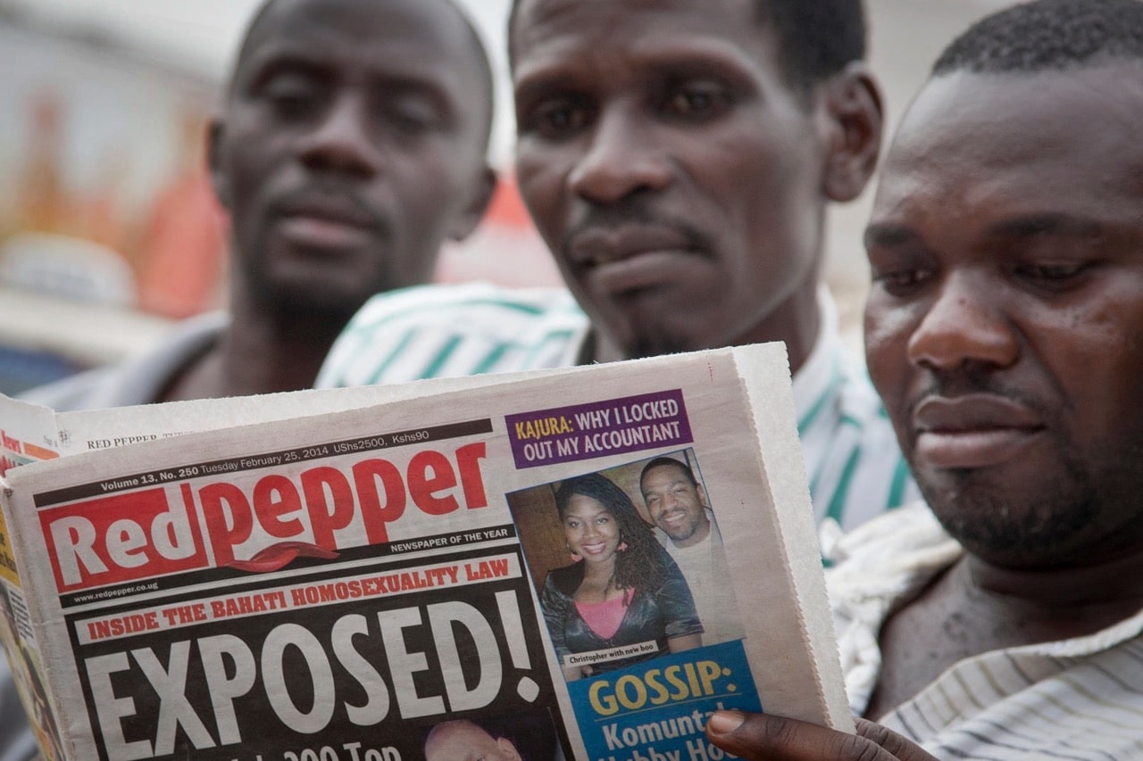 A man reads a copy of the "Red Pepper" tabloid newspaper in Kampala, Uganda, 25 February 2014, AP Photo/Rebecca Vassie