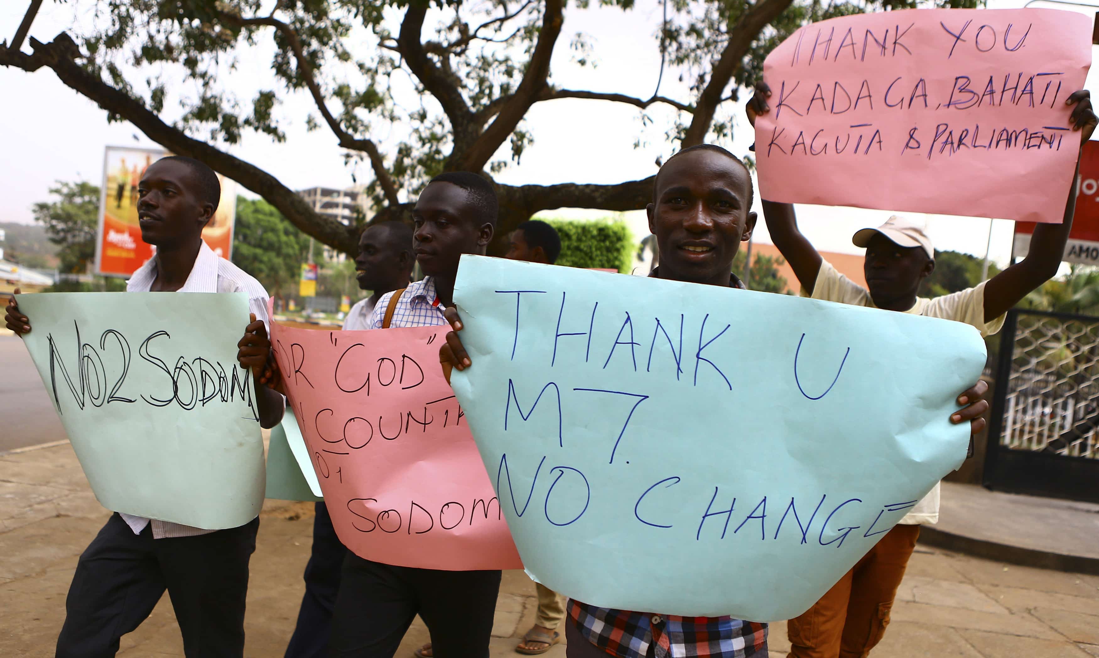 A group of people celebrate after Uganda's President Yoweri Museveni signed a law imposing harsh penalties for homosexuality in Kampala, 24 February 2014., REUTERS/Edward Echwalu