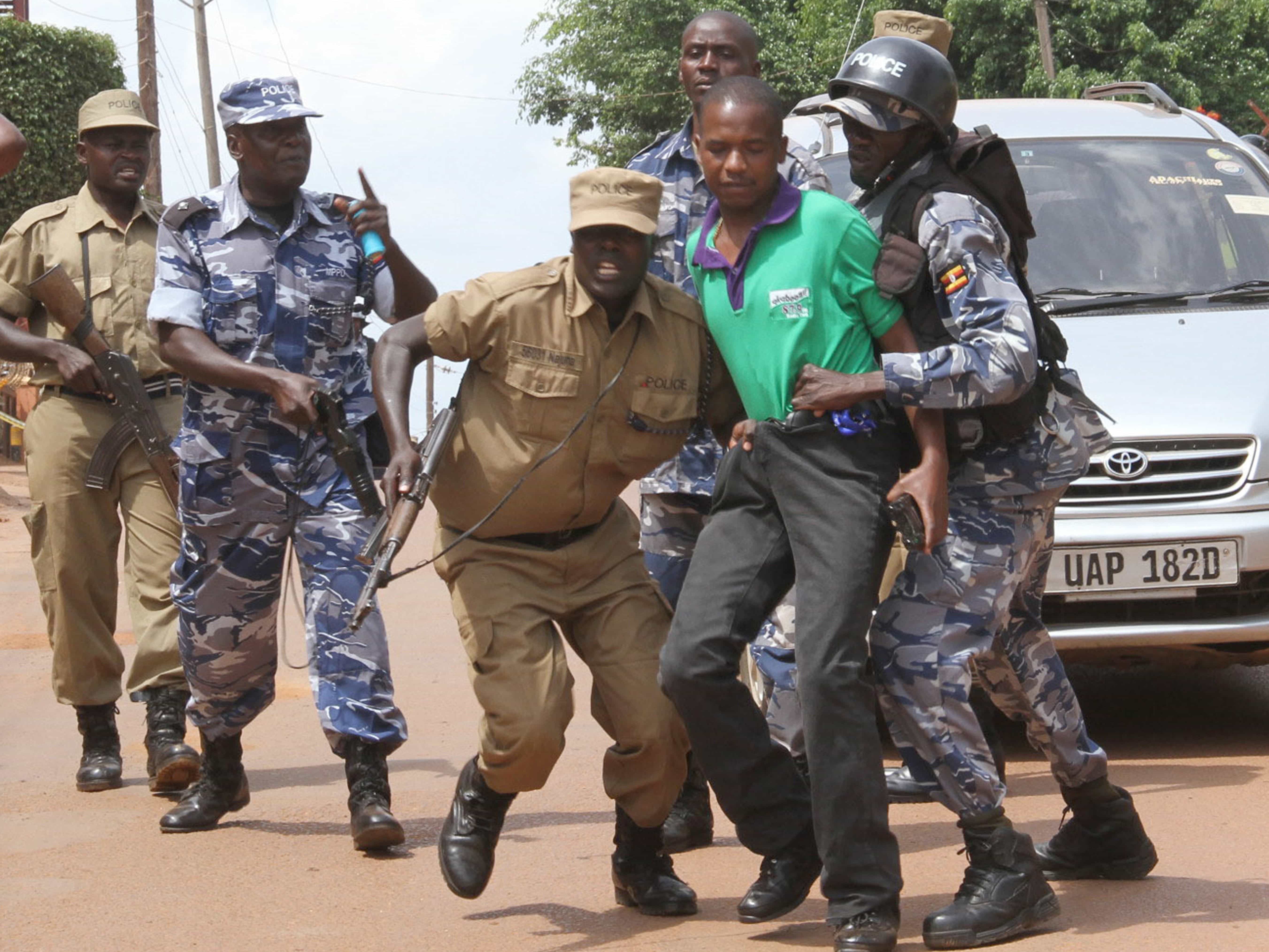 Ugandan police arrest a journalist outside the Daily Monitor offices in Kampala, 29 May 2013, AP Photo/Rebecca Vassie