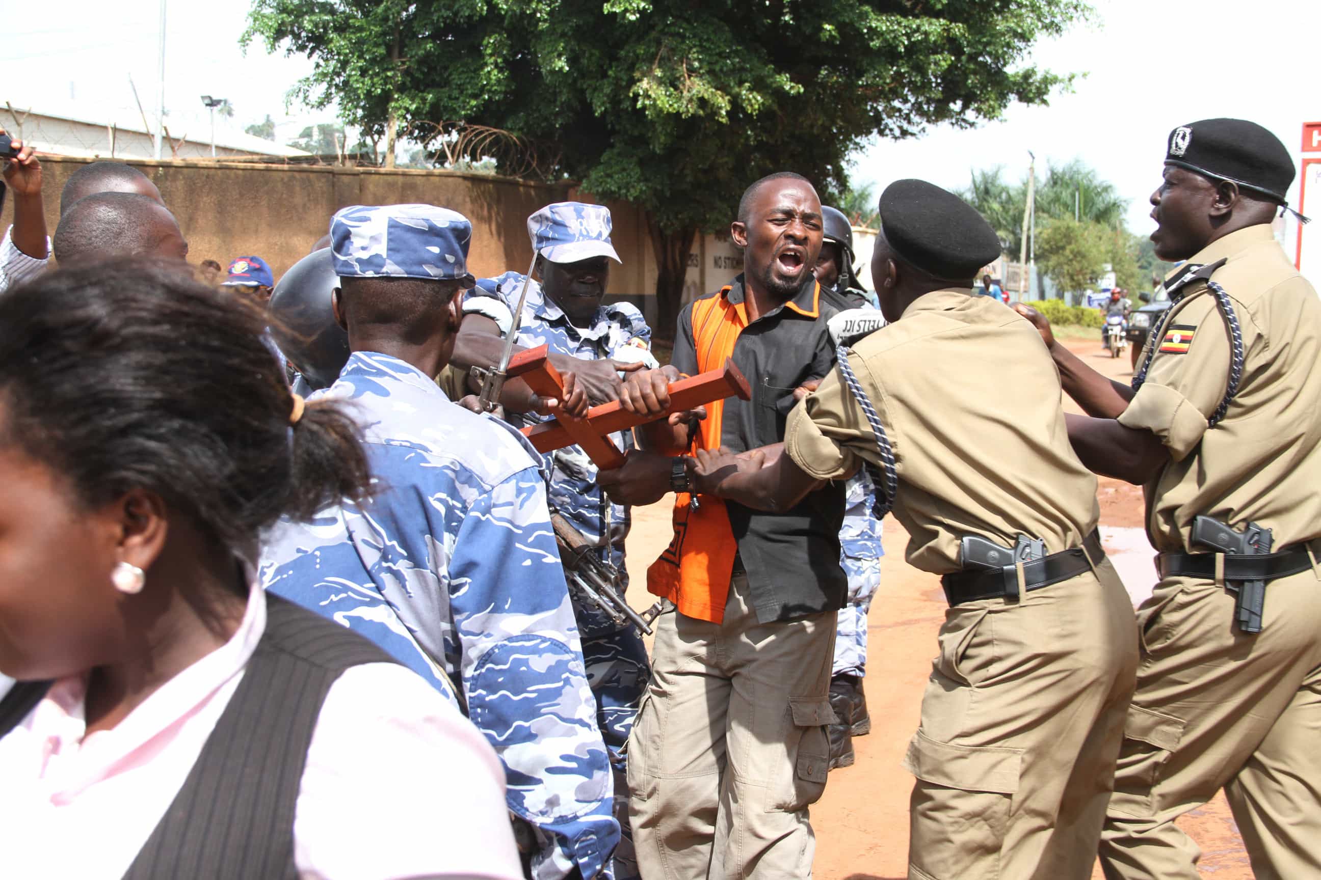 Police arrest a journalist at a demonstration against the seizure of media outlets in Kampala., Isaac Kasamani/Demotix