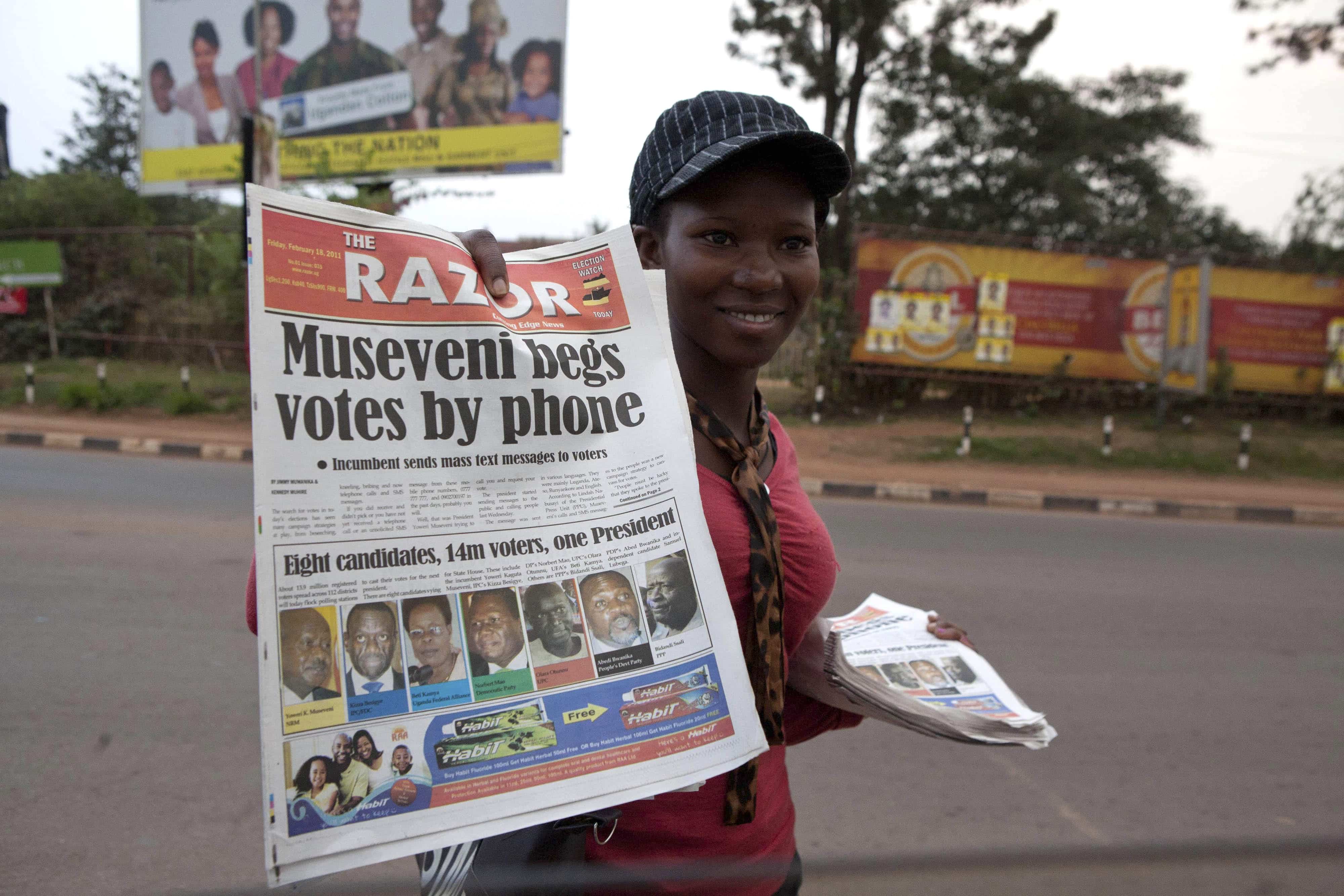 A newspaper vendor sells copies of a local newspaper in Kampala, 18 February 2011, AP Photo/ Michele Sibiloni