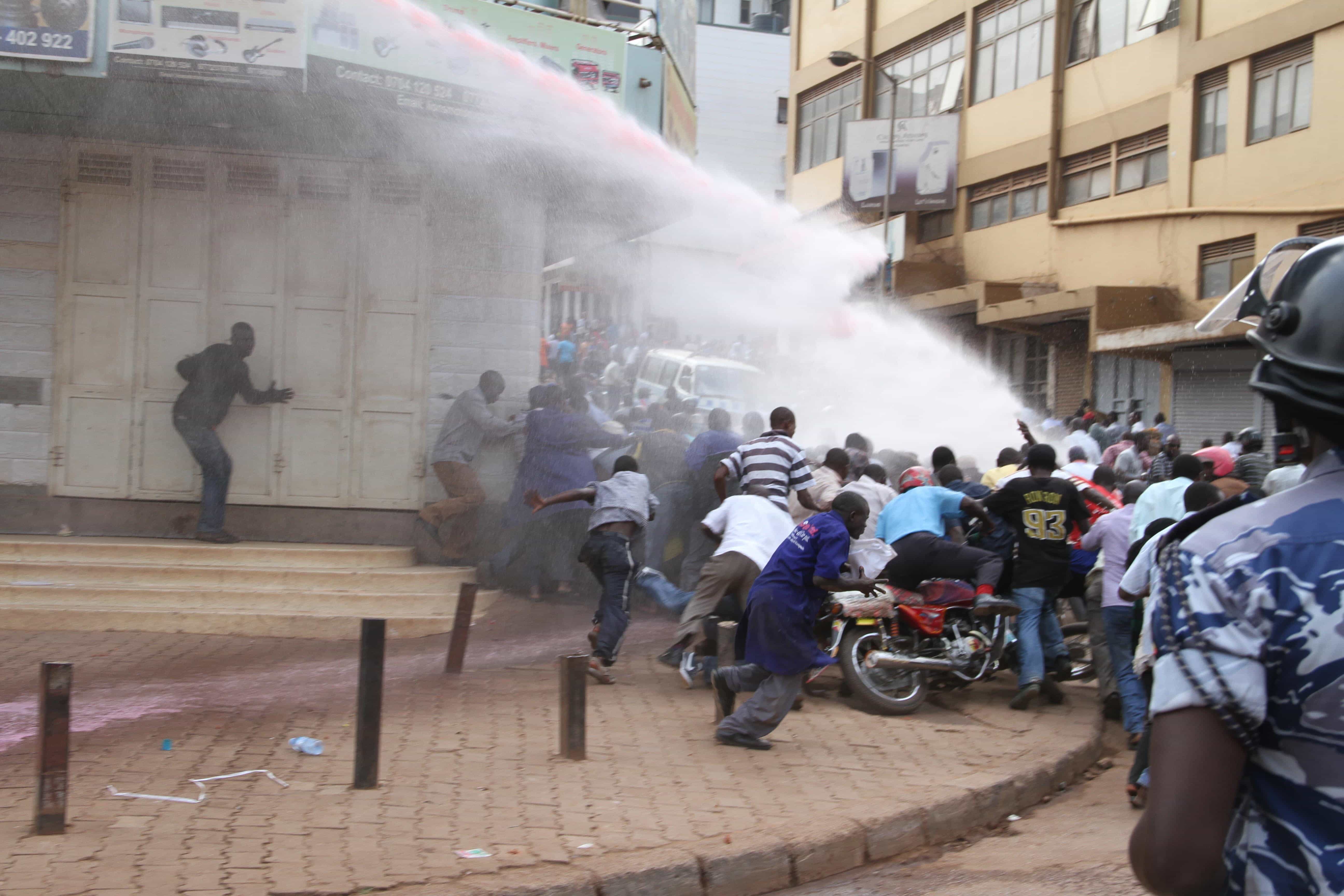 A Ugandan police water canon truck splashes teargas at protesters in Kampala, June 2013., Isaac Kasamani/Demotix