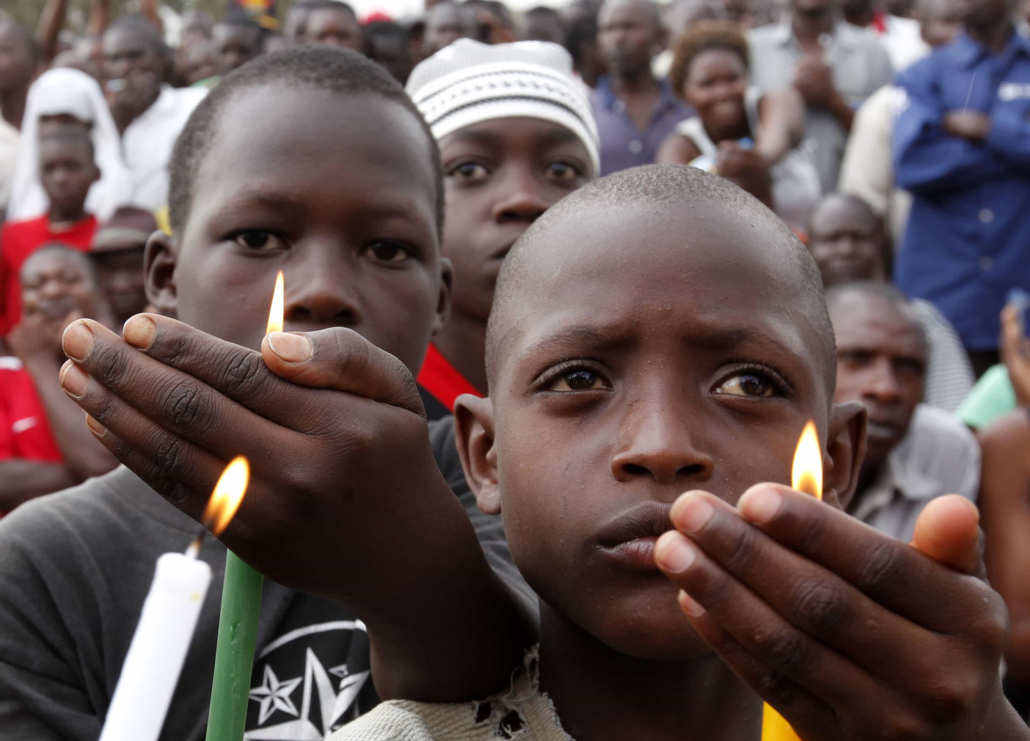 Children hold candles during a rally by Uganda's opposition parties in memory of the nine people who died during a government crackdown on protesters taking part in the "walk to work" campaign in Masaka town, Uganda, 10 August 2011, REUTERS/James Akena