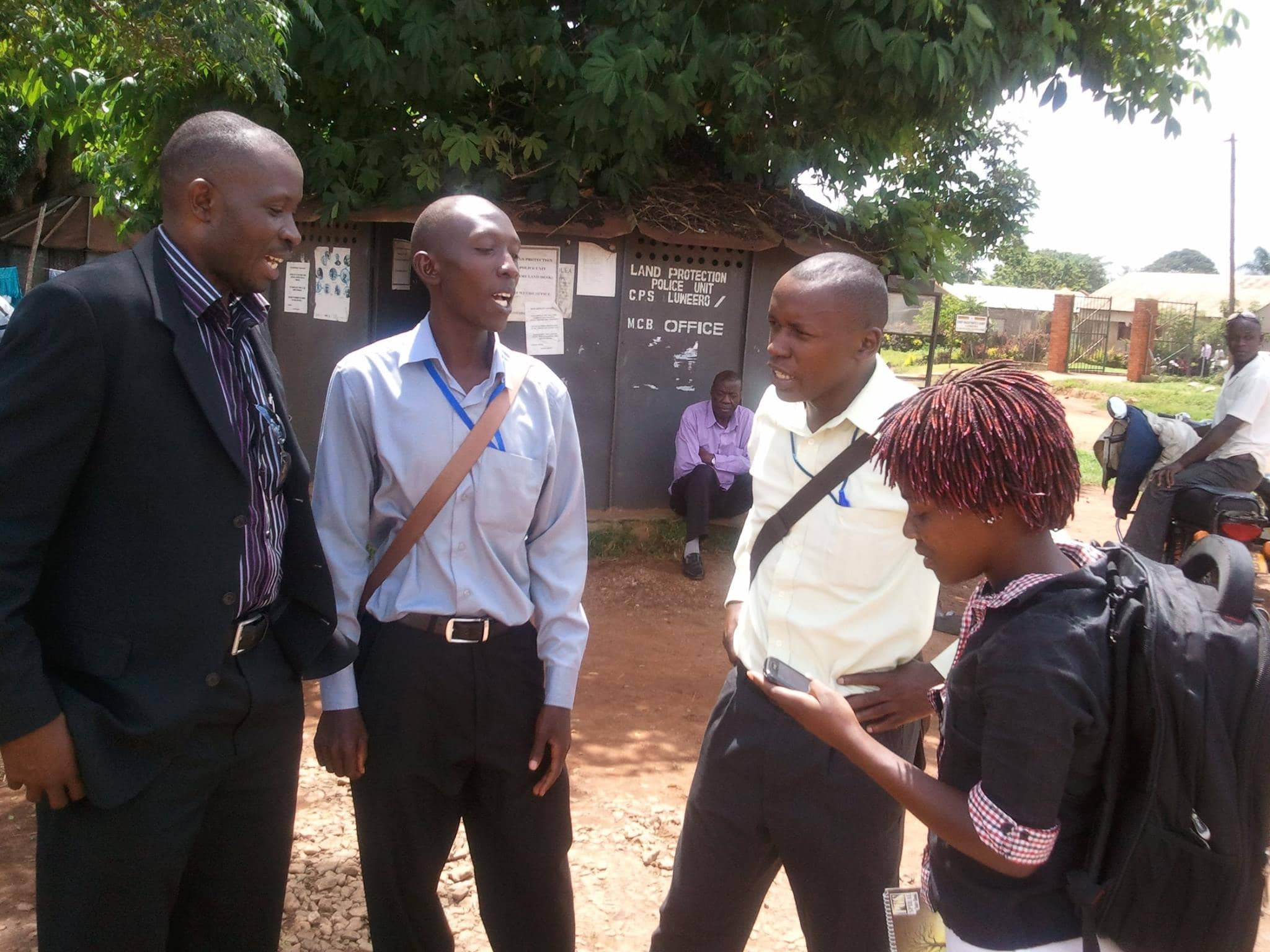 HRNJ-Uganda National Coordinator Robert Sempala stands with journalists Herbert Zziwa (2nd right) and Brian Luwaga (2nd left) at the Luweero Central Police Station., HRNJ-Uganda