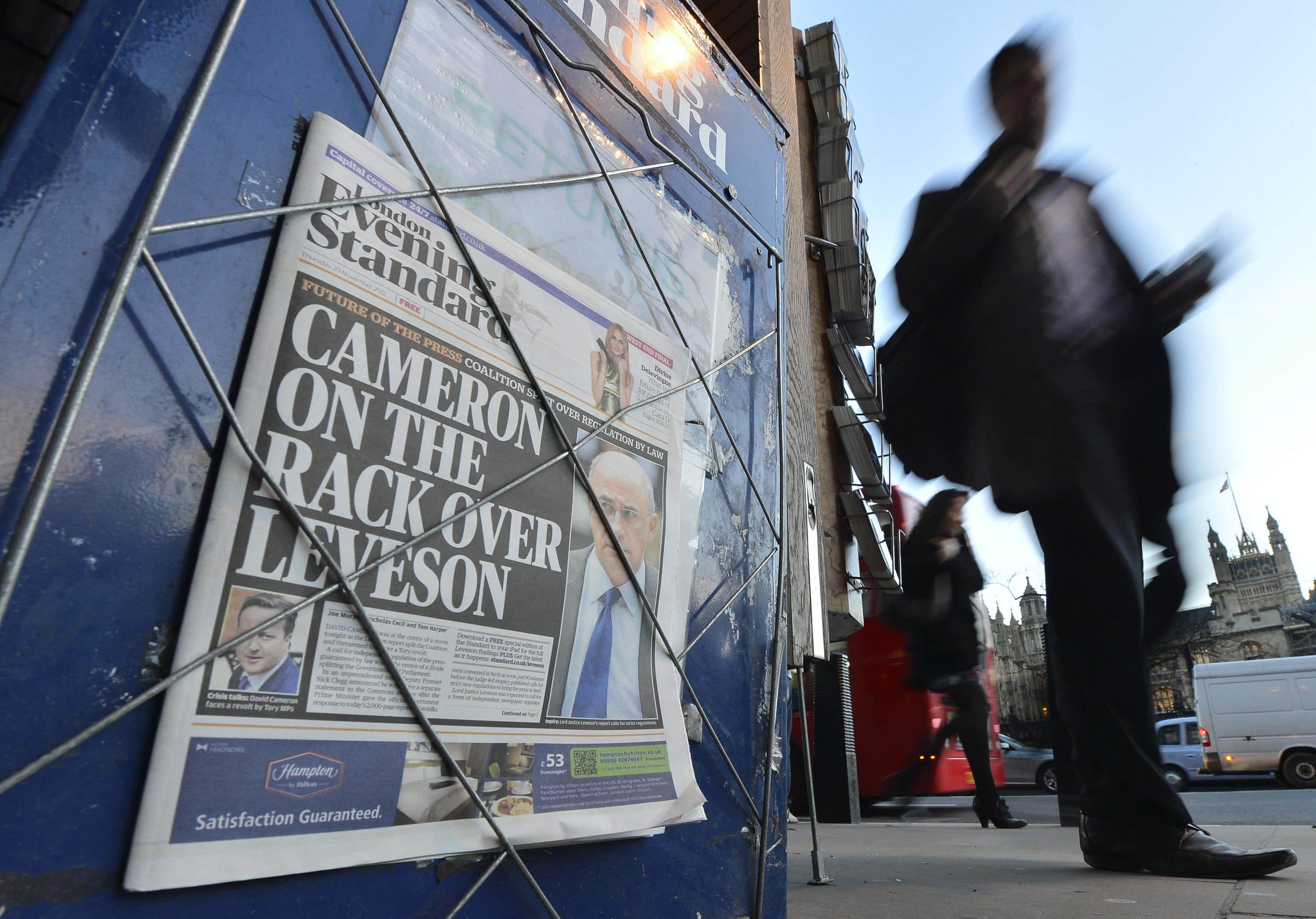 Lord Justice Brian Leveson appears on the front page of an evening newspaper after his report on media ethics was released in central London., REUTERS/Toby Melville