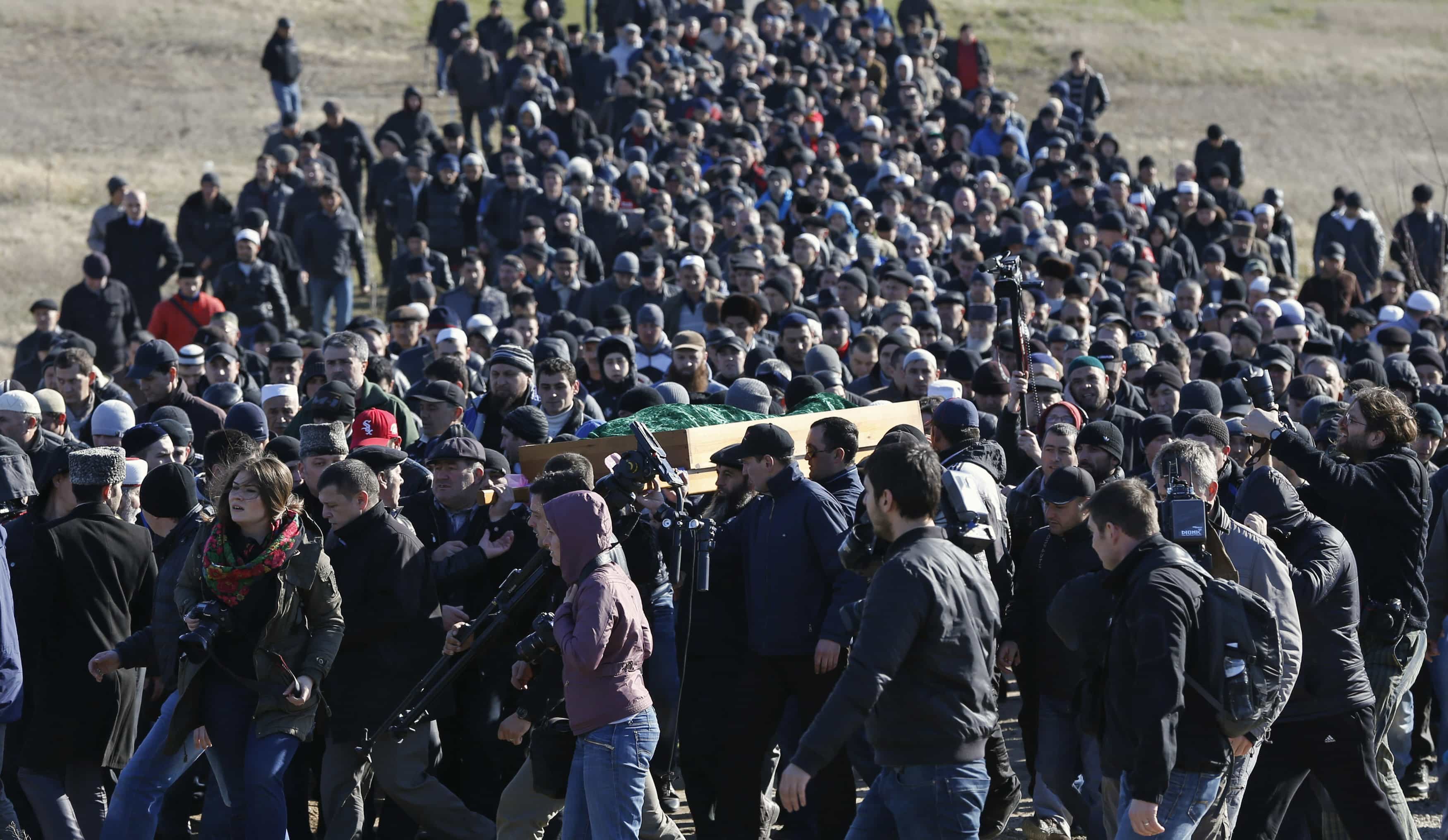 Crimean Tatars gather at a cemetery for the funeral of Reshat Ametov outside the town of Simferopol, 18 March 2014., REUTERS/Vasily Fedosenko