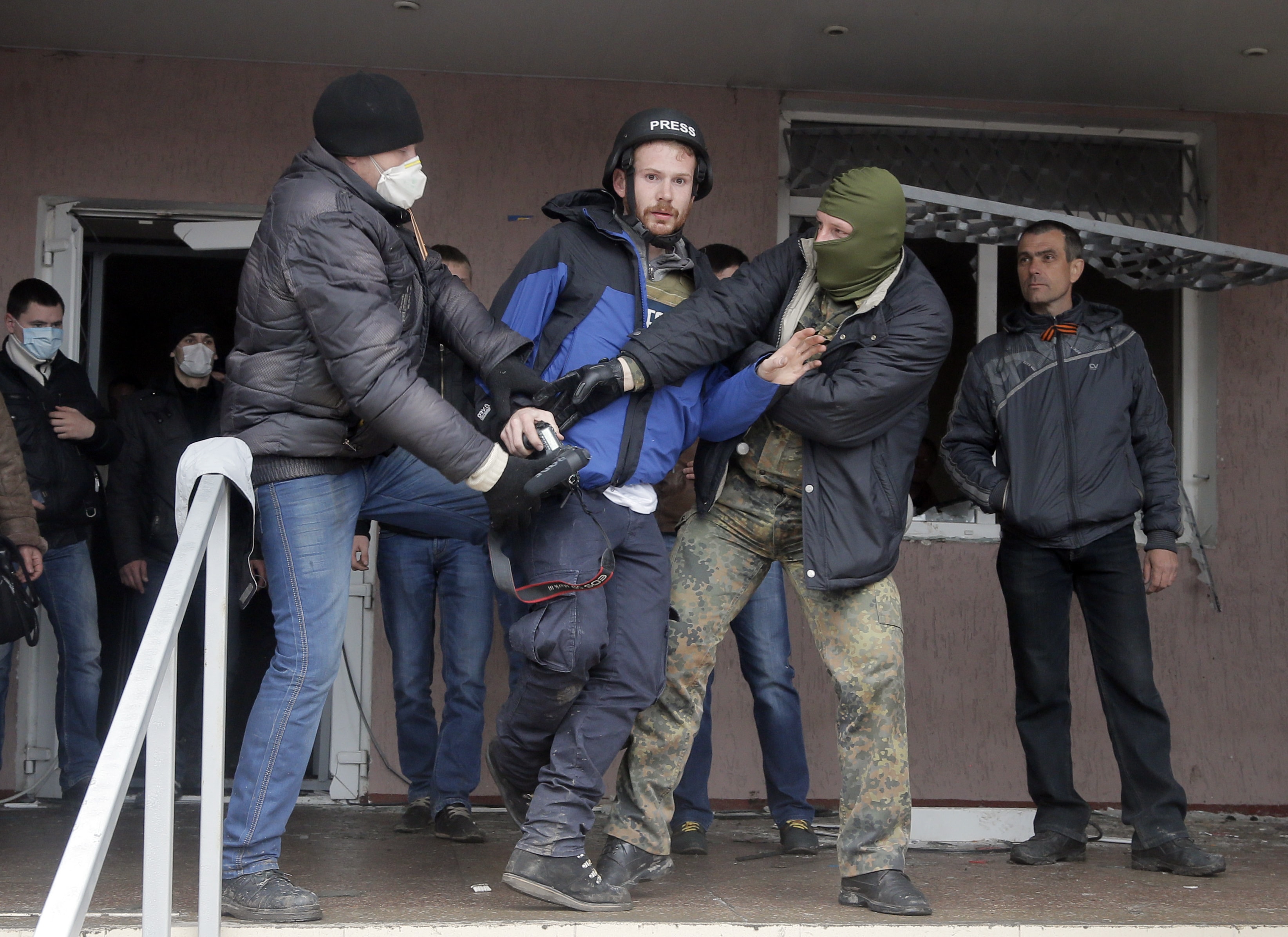 Masked pro-Russian men attack British journalist Frederick Paxton during the mass storming of a police station in the Ukrainian town of Horlivka, 14 April 2014., AP Photo/Efrem Lukatsky