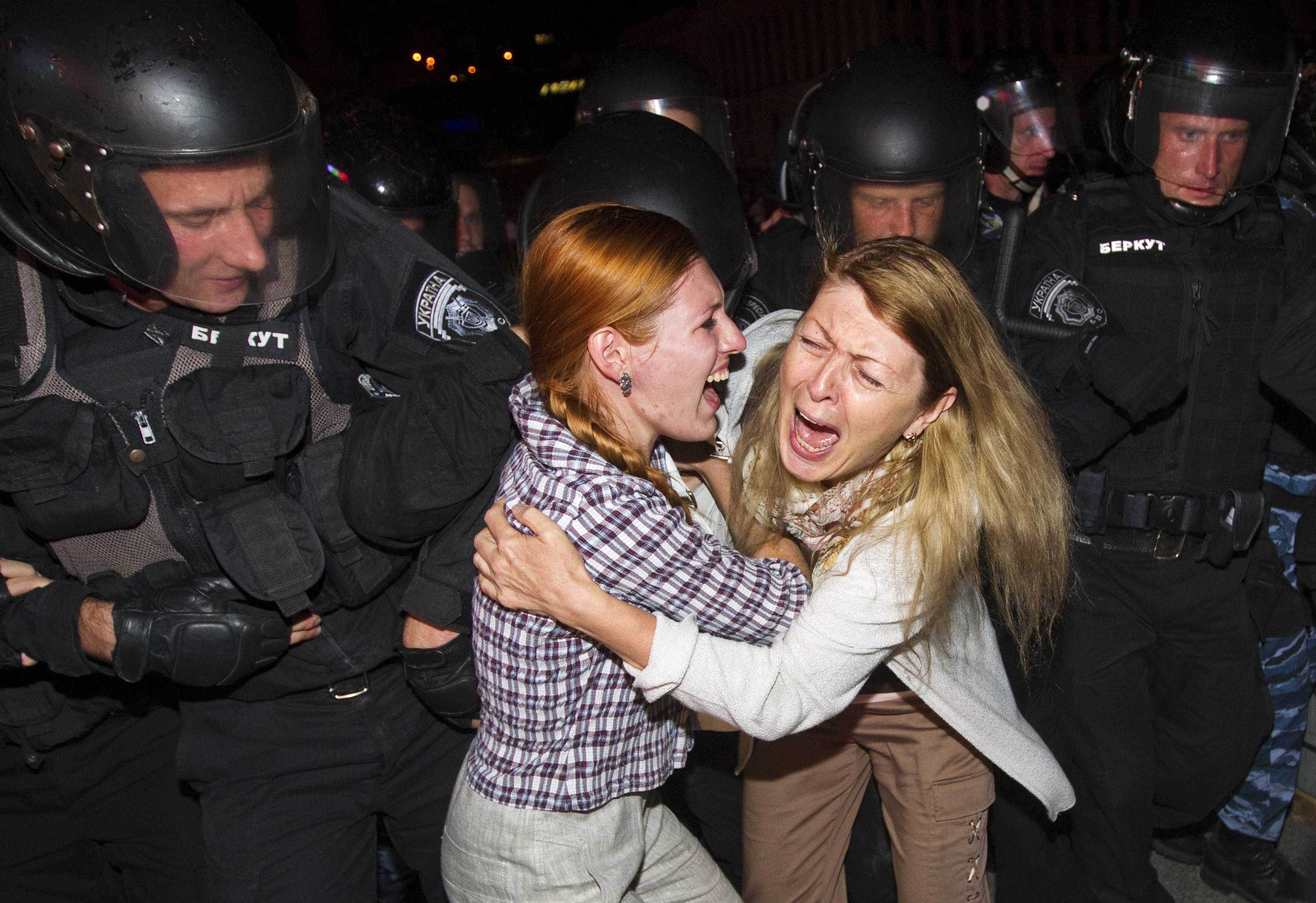 Protesters react in front of riot policemen during a demonstration against last month's rape of 29-year-old shop assistant Iryna Krashkova, in central Kyiv early July 19, 2013. , Reuters