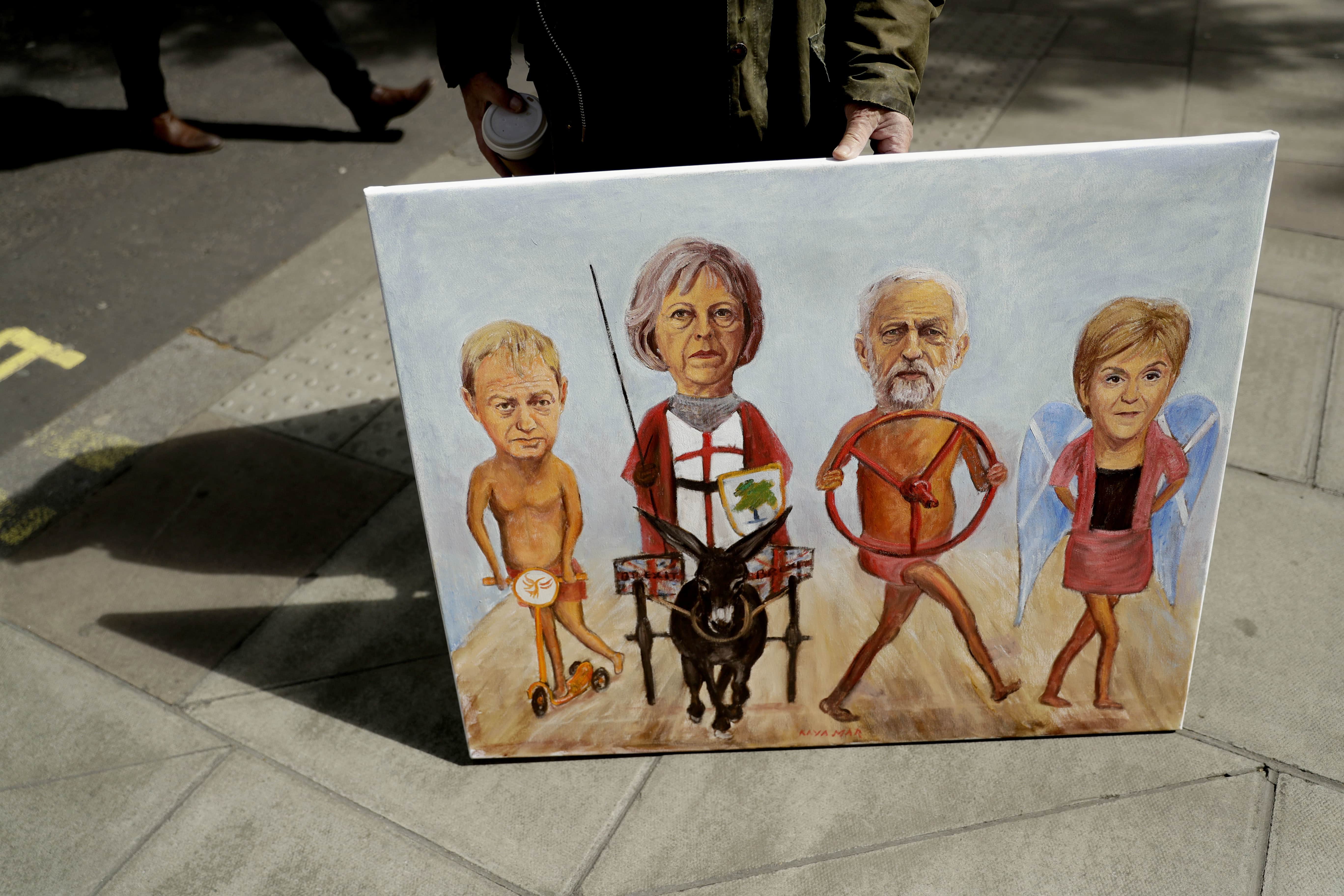 Artist Kaya Mar poses with his painting to mark the start of the election campaign race in London, 26 April 2017. Pictured are, from left, Liberal Democrats party leader Tim Farron, Theresa May, Jeremy Corbyn and leader of the Scottish National Party Nicola Sturgeon, AP Photo/Matt Dunham