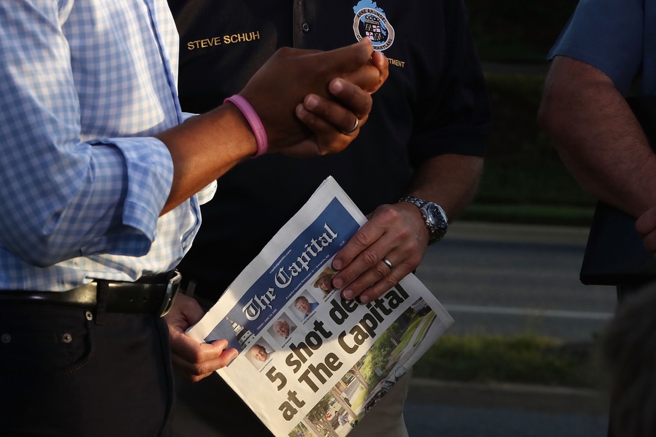 Anne Arundel County Executive Steven Schuh holds the day's edition of the "Capital Gazette" in Annapolis, Maryland, 29 June 2018, Mark Wilson/Getty Images