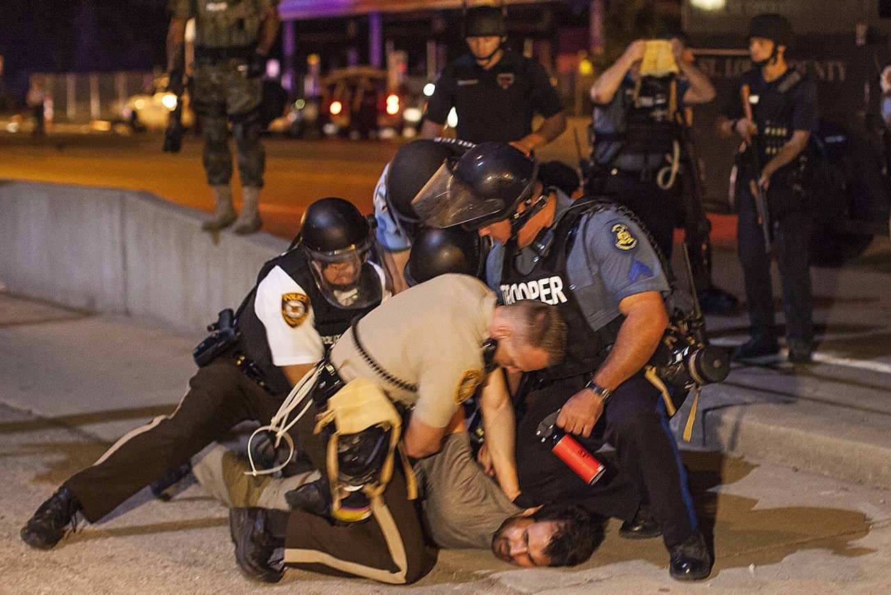 Anadolu Agency's correspondent in the U.S, Bilgin Sasmaz, is taken into custody by police while covering protests over the killing of an unarmed black teenager, in Ferguson, Missouri, 20 August 2014, Samuel Corum/Anadolu Agency/Getty Images