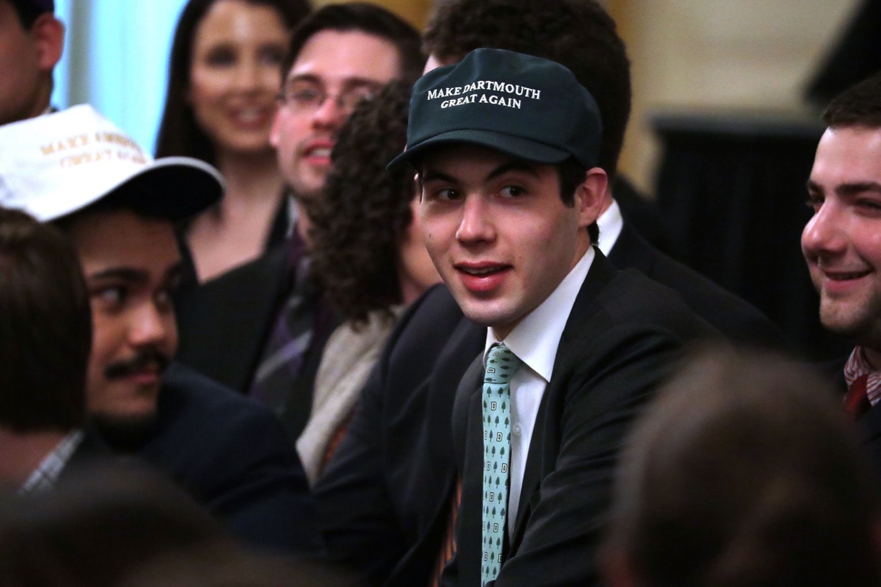 A young man wears a 'Make Dartmouth Great Again' hat before President Donald Trump signs an executive order protecting freedom of speech on college campuses, at the White House in Washington, DC., 21 March 2019, Chip Somodevilla/Getty Images