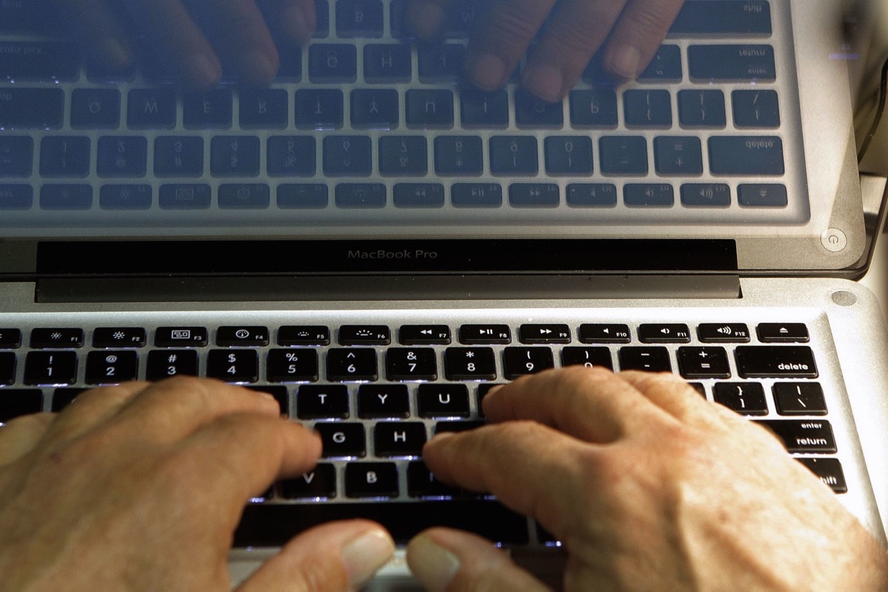 In this 27 February 2013 file photo illustration, a man types on a keyboard in Los Angeles, AP Photo/Damian Dovarganes, File