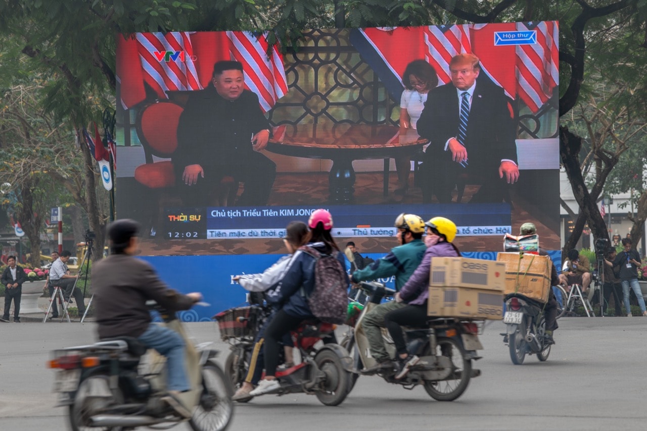 Traffic passes a large LED screen showing Kim Jong-un and Donald Trump during the USA-DPRK summit, in Hanoi, Vietnam, 28 February 2019, Carl Court/Getty Images