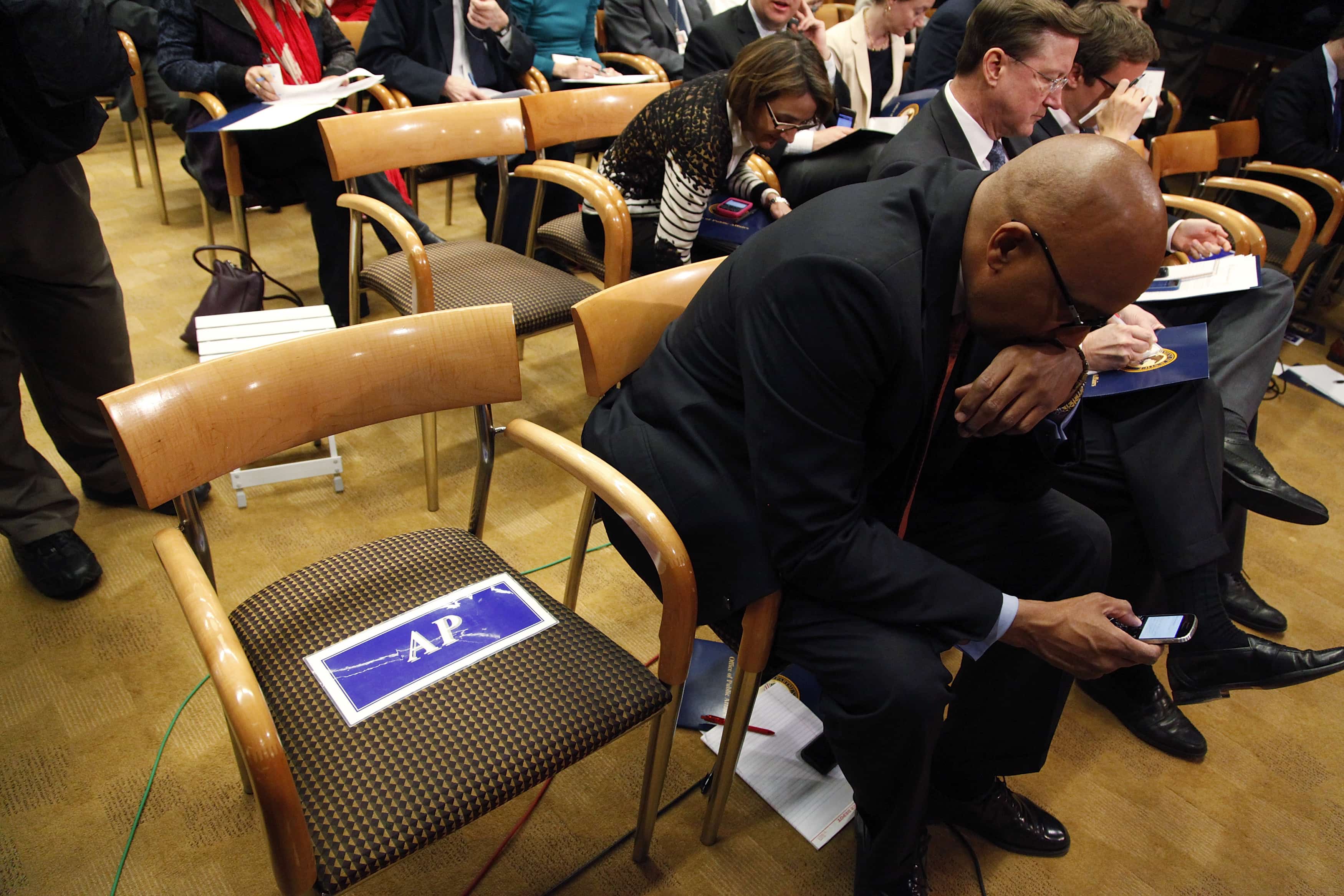 The seat reserved for the Associated Press is empty before U.S. Attorney General Eric Holder addresses a news conference, 14 May 2013, REUTERS/Jonathan Ernst