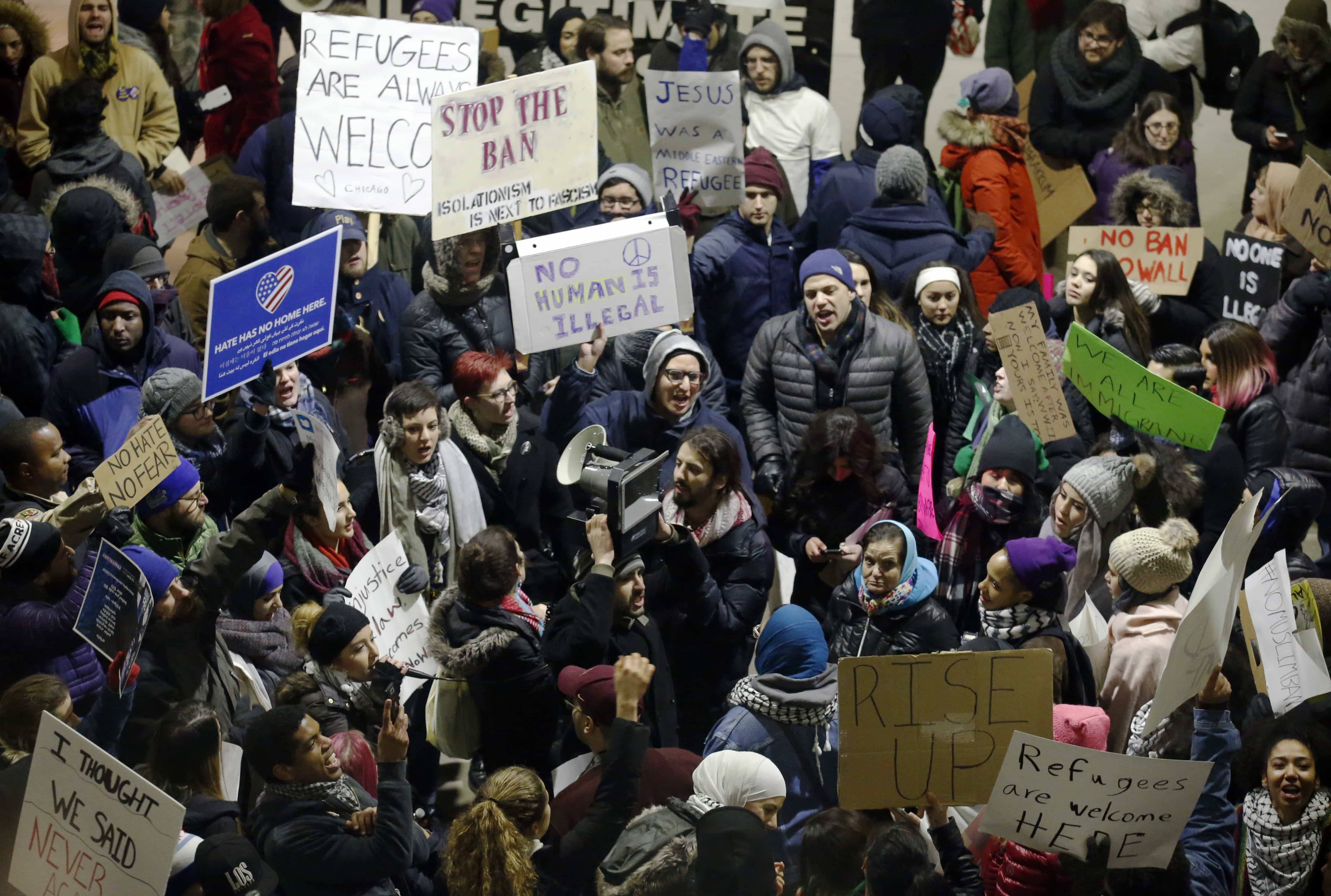 Demonstrators converge outside Terminal 5 of O'Hare International Airport, 29 January 2017, in Chicago, AP Photo/Nam Y. Huh