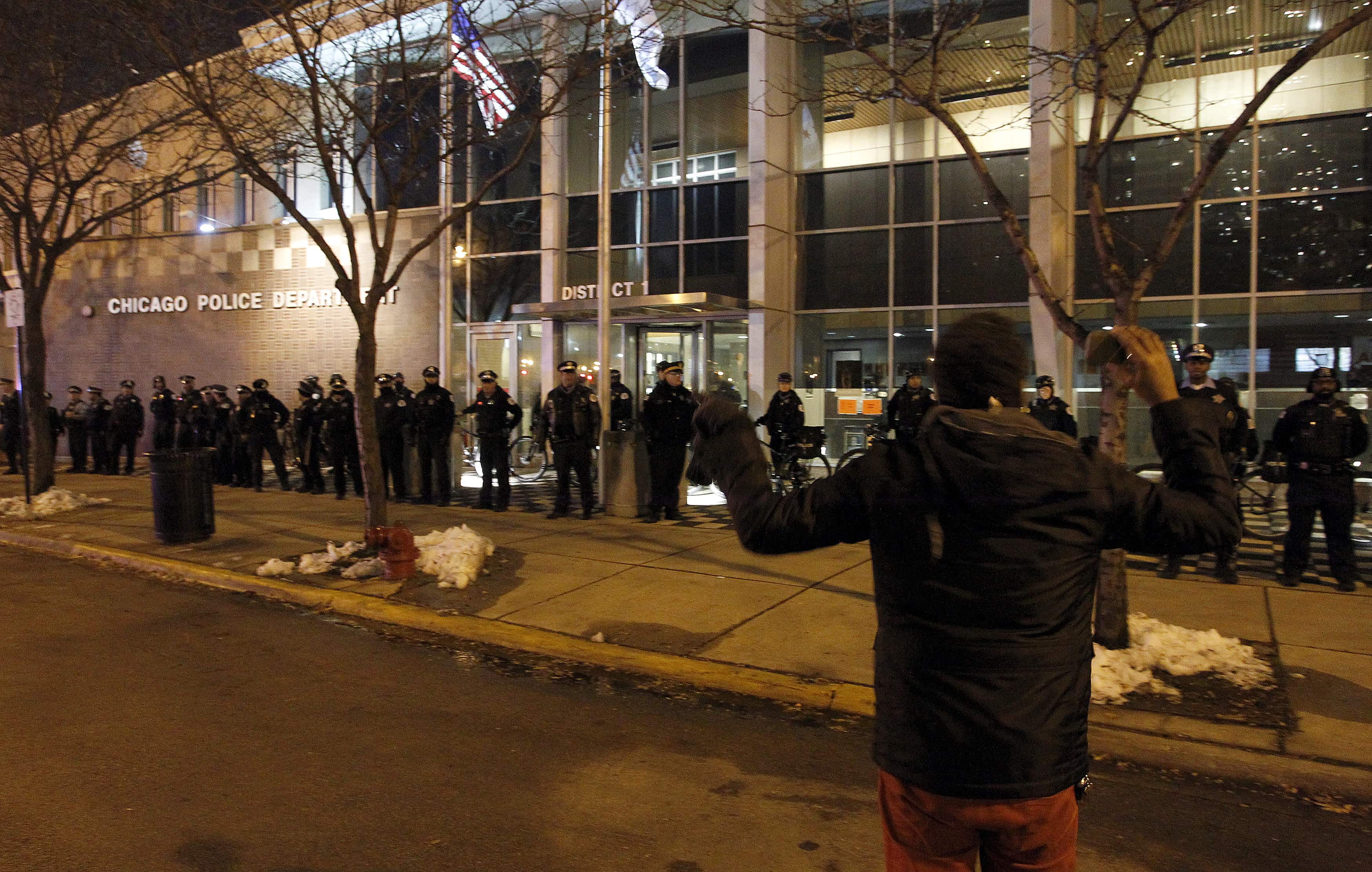 A protester shouts at Chicago police officers hours before the release of a video showing an officer shooting Laquan McDonald, REUTERS/Frank Polich