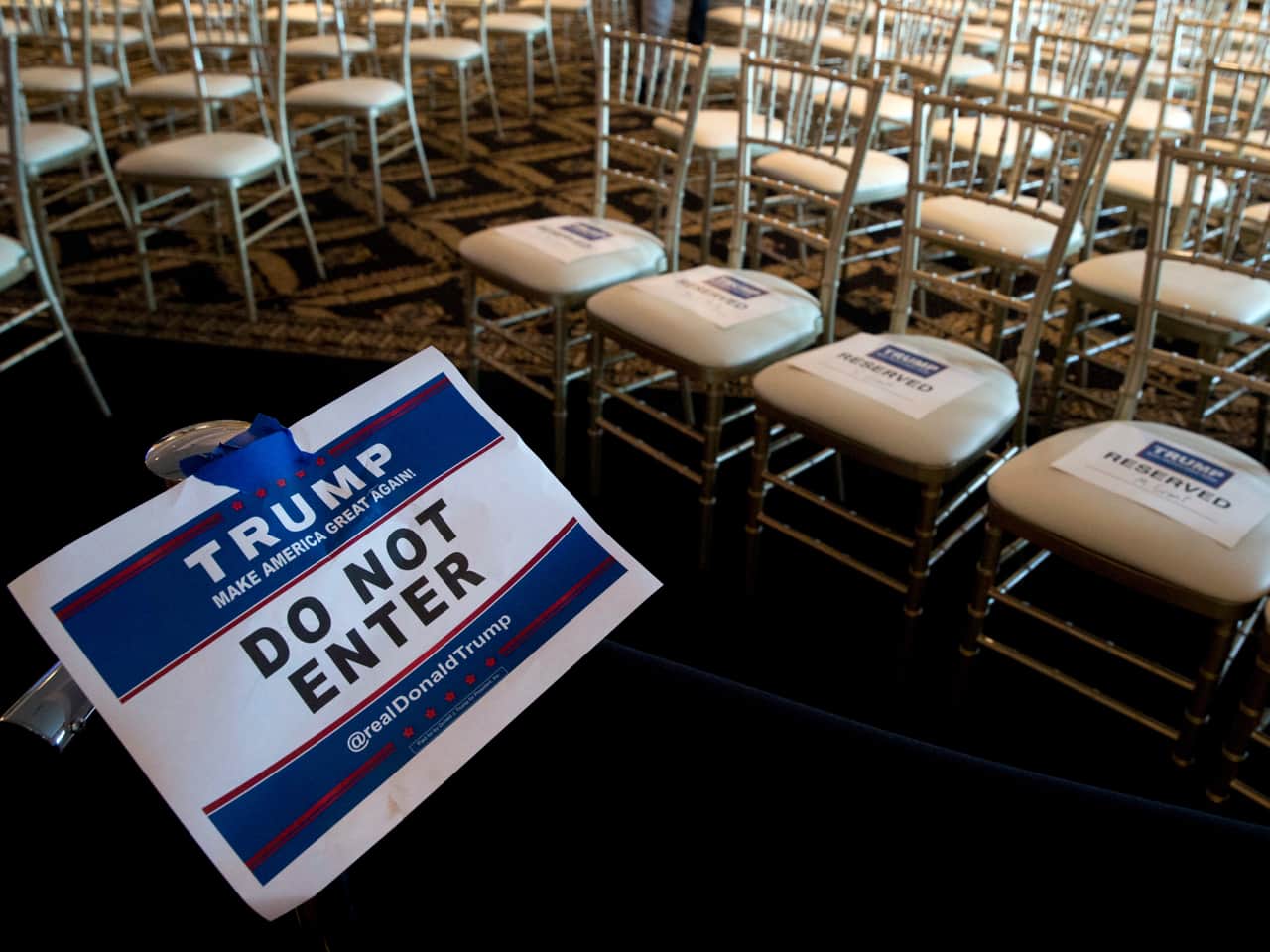In this 7 June 2016 file photo, a sign separates members of the media from invited guests at Donald Trump's news conference at the Trump National Golf Club Westchester, N.Y., Photo/Mary Altaffer, File