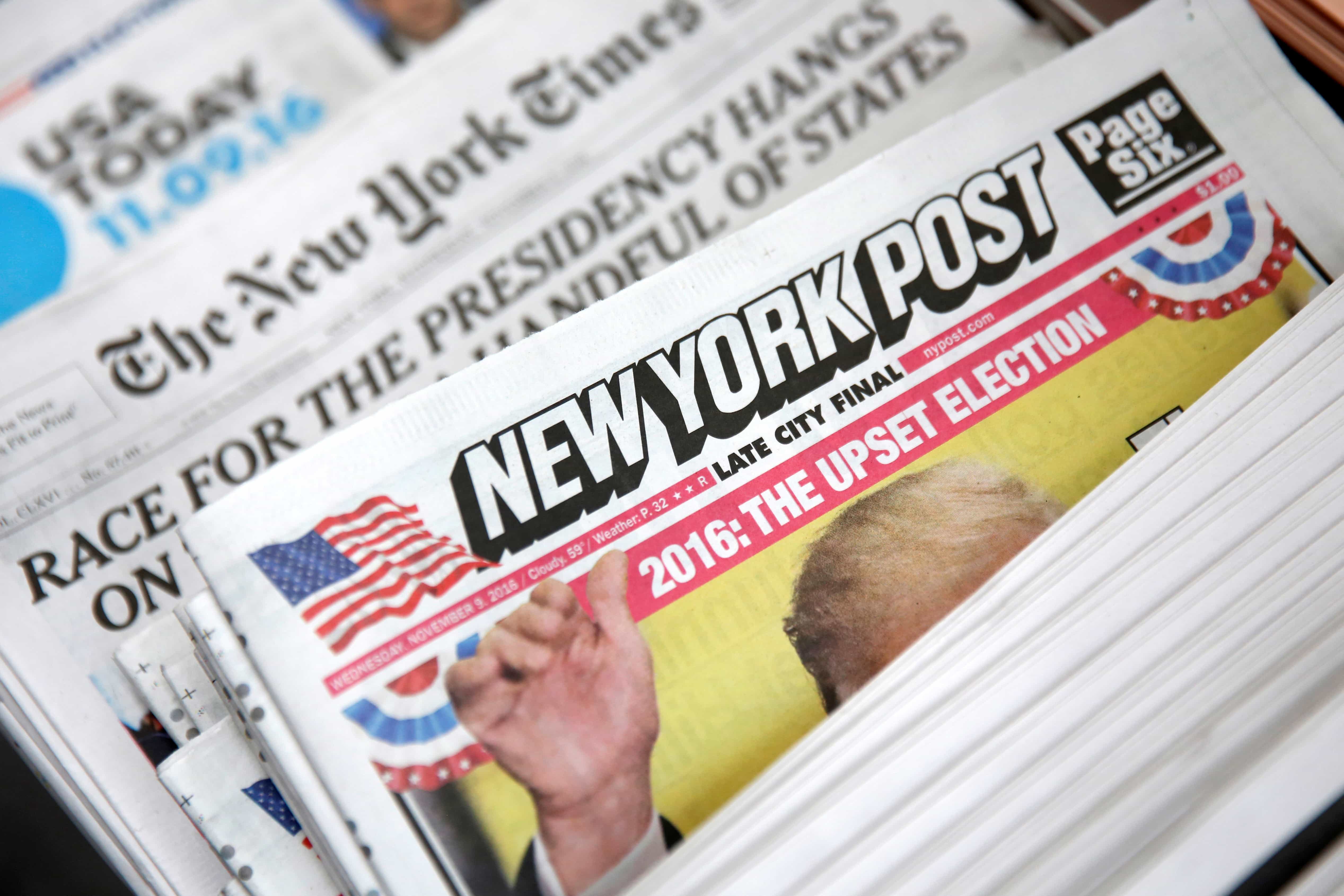 The cover of the New York Post newspaper is seen with other papers at a newsstand in New York U.S., 9 November 2016, REUTERS/Shannon Stapleton