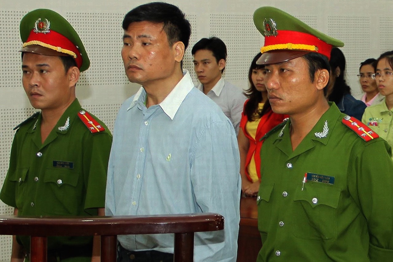 Blogger Truong Duy Nhat (C) stands trial at a local People's Court in the central city of Da Nang, Vietnam, 4 March 2014, Vietnam News Agency/AFP/Getty Images