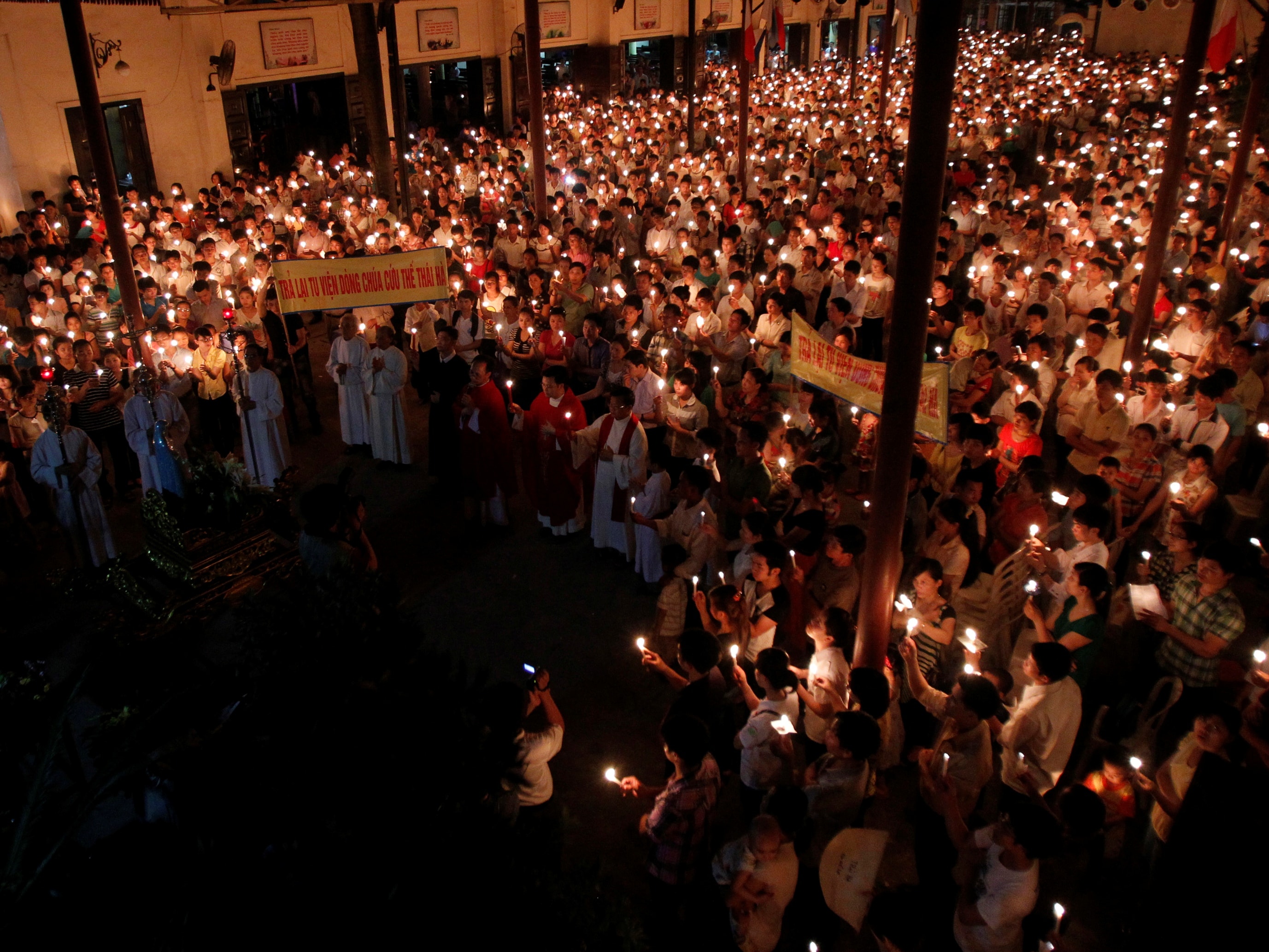 Catholics attend a Pentecost vigil mass in Hanoi, 19 May 2013; people also prayed for the 14 political activists who are appealing their sentencing, REUTERS/Kham