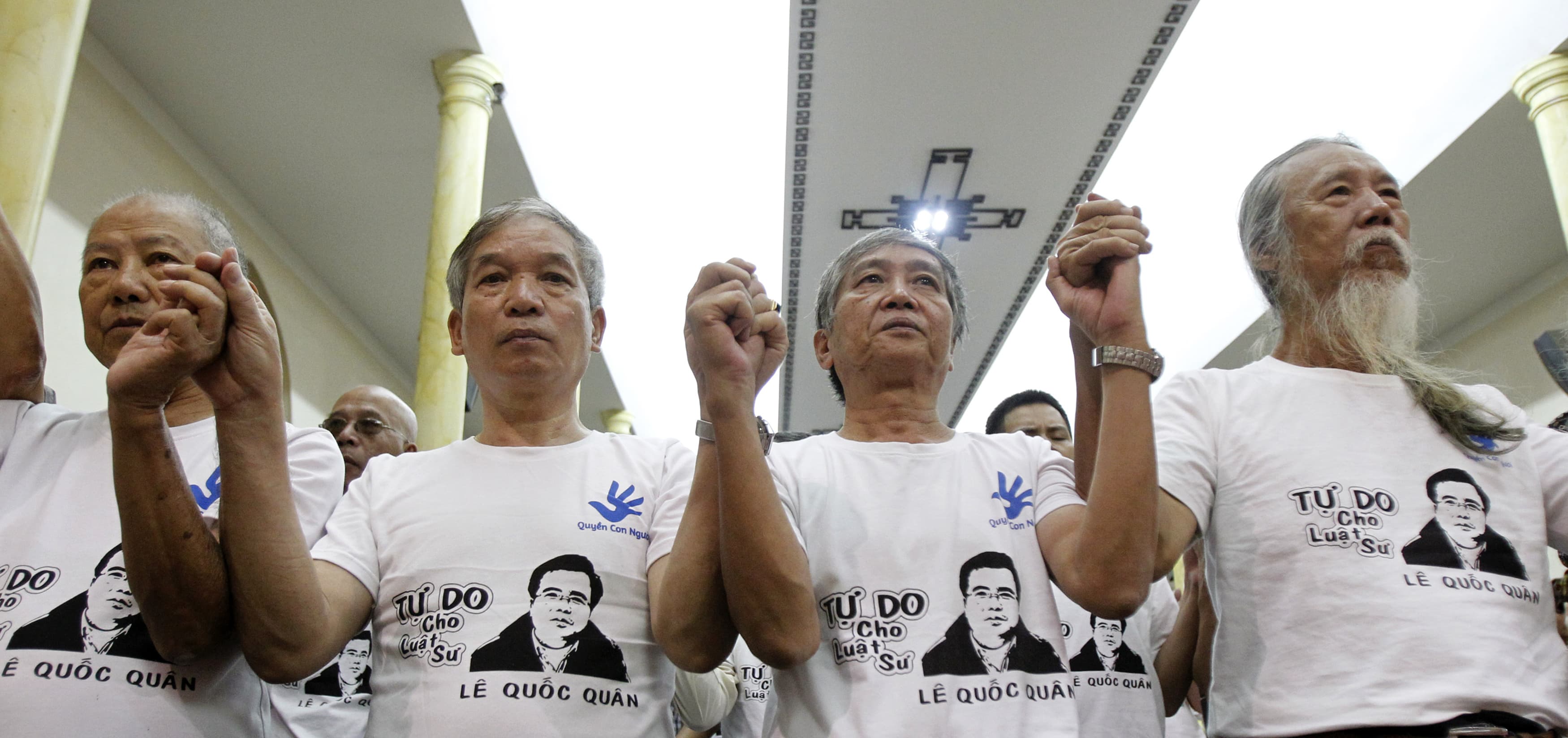 Friends and supporters wearing t-shirts with the image of lawyer Le Quoc Quan attend a mass calling for Quan to be freed at a church in Hanoi, 29 September 2013, REUTERS/Kham
