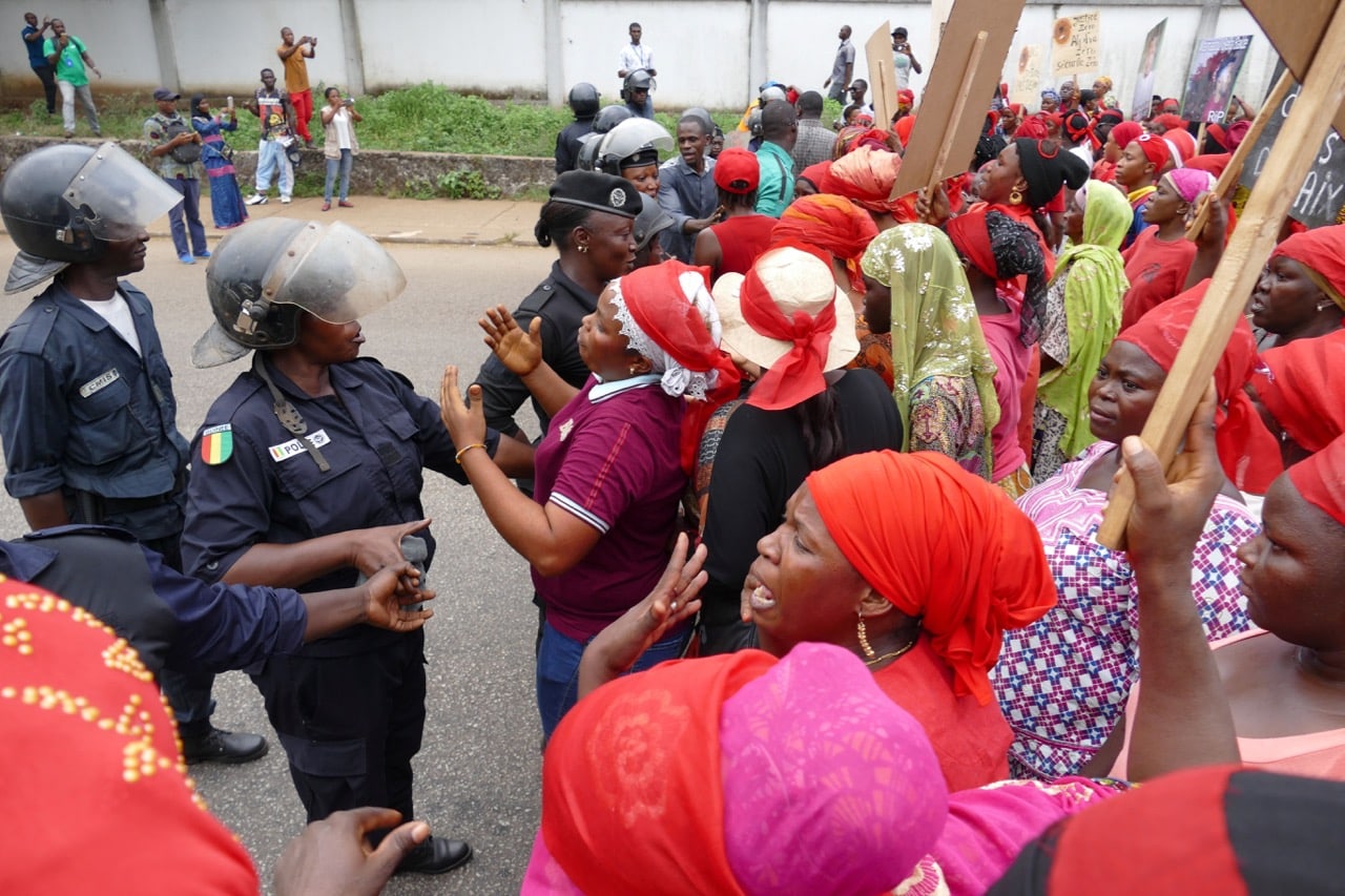 Police face women opposition supporters during a protest against a series of bloody crackdowns on opposition demonstrations, in Conakry, Guinea, 13 November 2018, CELLOU BINANI/AFP/Getty Images