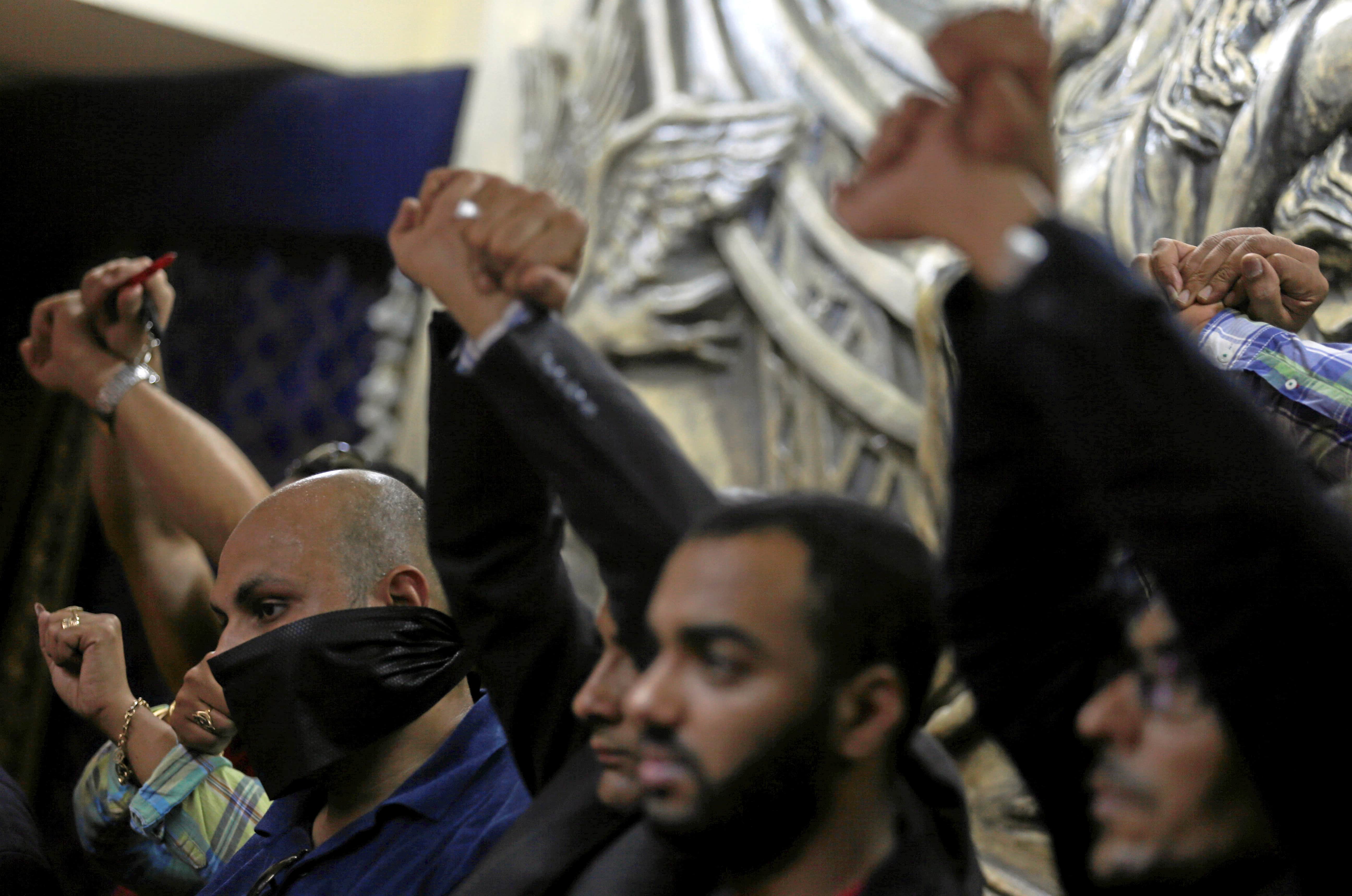 Journalists gesture in protest against the arrests of their peers during a news conference at the Egyptian press syndicate's headquarters in Cairo, Egypt May 3, 2016, REUTERS/Amr Abdallah Dalsh