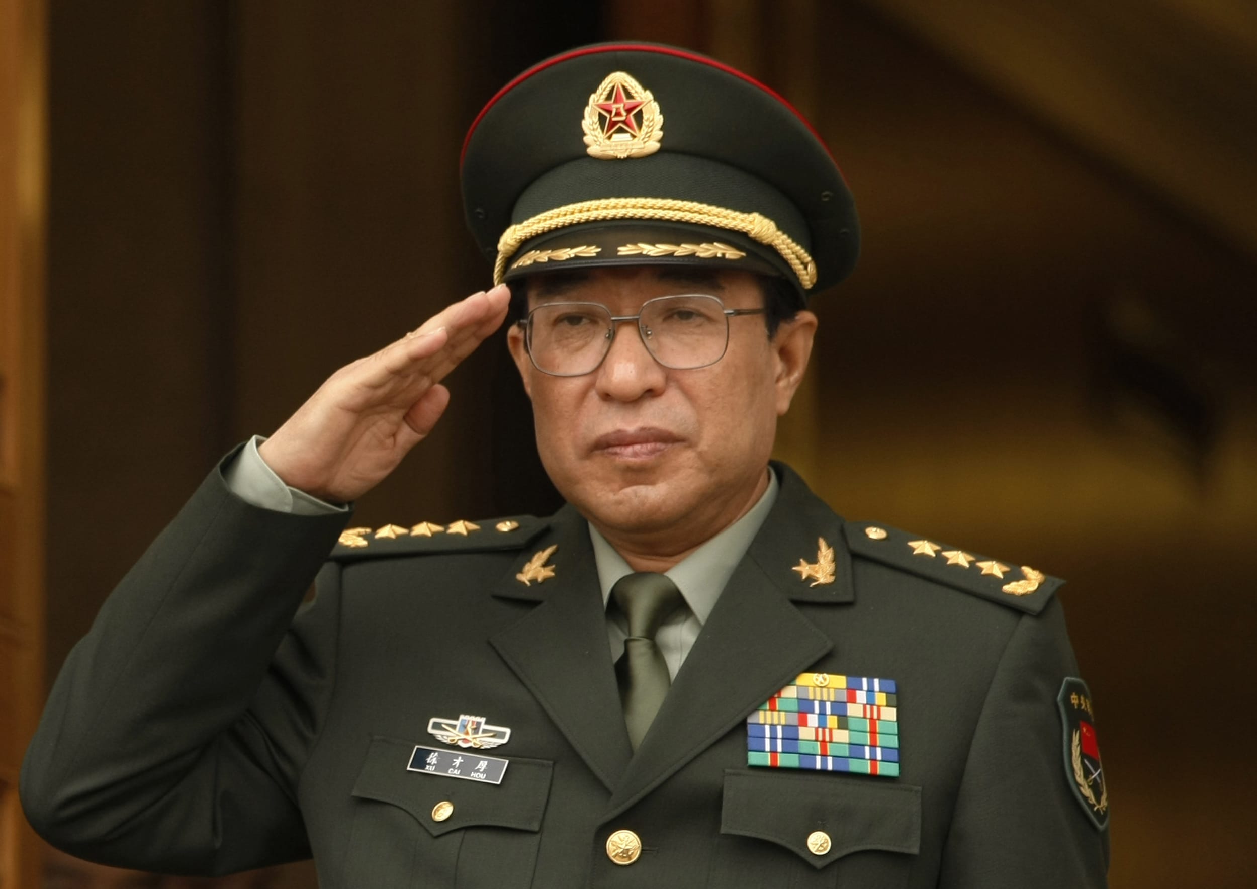 The late Xu Caihou listens to national anthems during a welcome ceremony at the Pentagon in Washington, in this October 27, 2009 file photo., REUTERS/Kevin Lamarque/Files