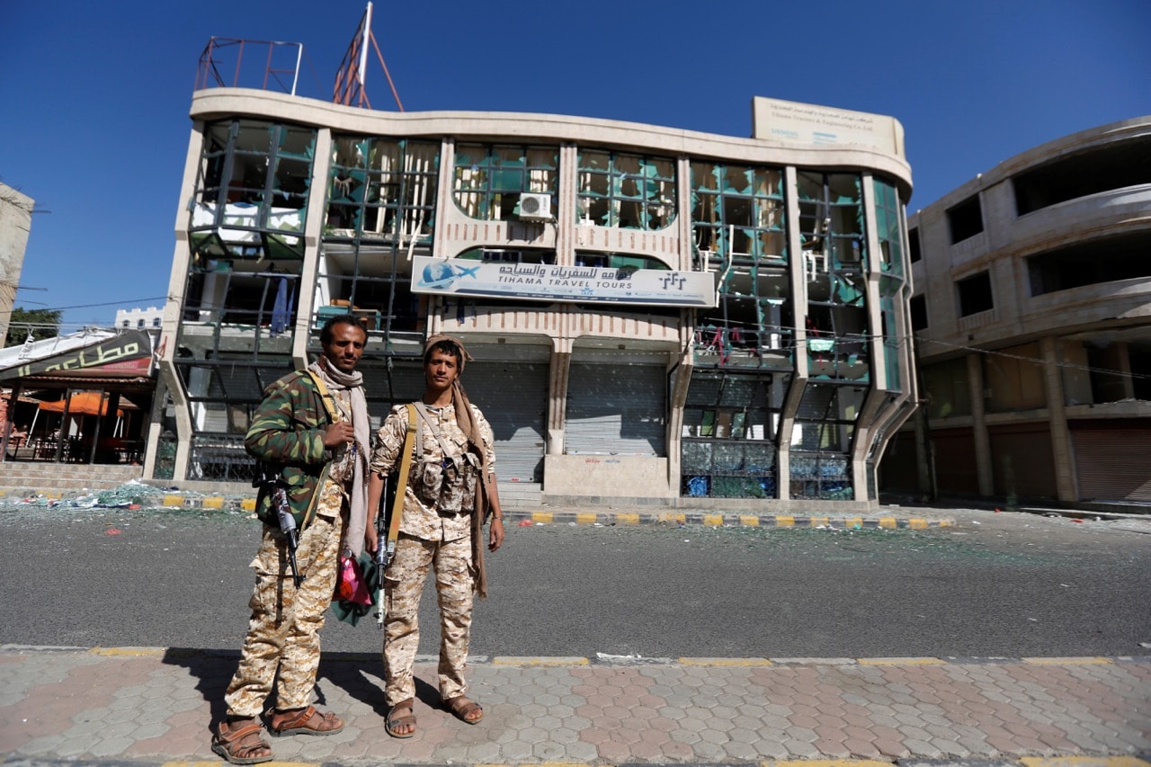 Houthi fighters pose in front of a damaged building on a street where Houthis have recently clashed with forces loyal to slain Yemeni former president Ali Abdullah Saleh in Sanaa, 6 December 2017, REUTERS/Khaled Abdullah